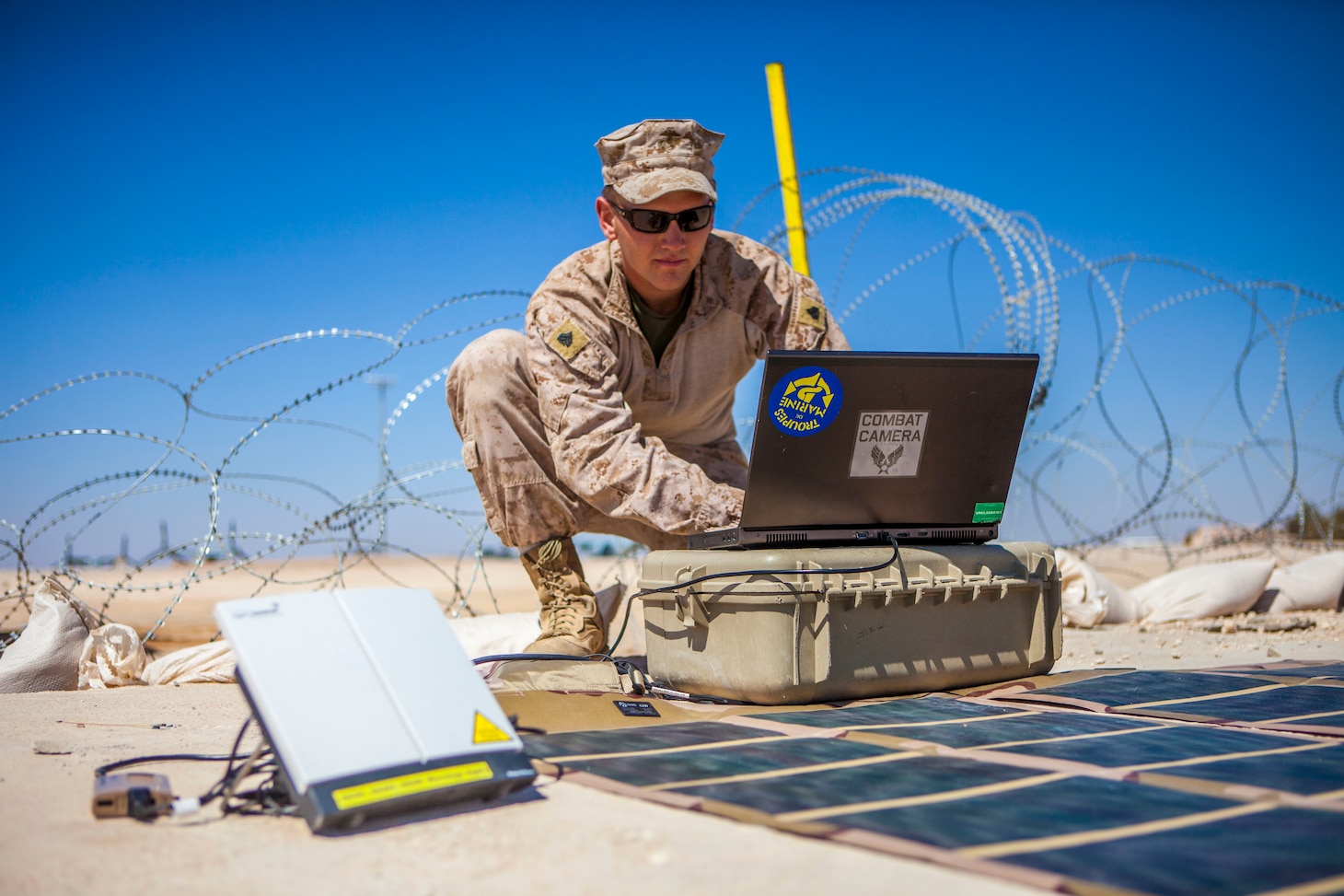 U.S. Marine Sgt. Christopher Q. Stone, 26th Marine Expeditionary Unit (MEU) combat cameraman, transmits imagery using a Broadband Global Area Network (BGAN) powered by a Solar Portable Alternative Communications Energy System (SPACES) kit from King Faisal Air Base in Jordan to the USS Kearsarge (LHD 3) at sea, June 18, 2013. Exercise Eager Lion 2013 is an annual, multinational exercise designed to strengthen military-to-military relationships and enhance security and stability in the region by responding to modern-day security scenarios. The 26th MEU is a Marine Air-Ground Task Force forward-deployed to the U.S. 5th Fleet area of responsibility aboard the Kearsarge Amphibious Ready Group serving as a sea-based, expeditionary crisis response force capable of conducting amphibious operations across the full range of military operations. (U.S. Marine Corps photo by Sgt. Christopher Q. Stone, 26th MEU Combat Camera/Released)