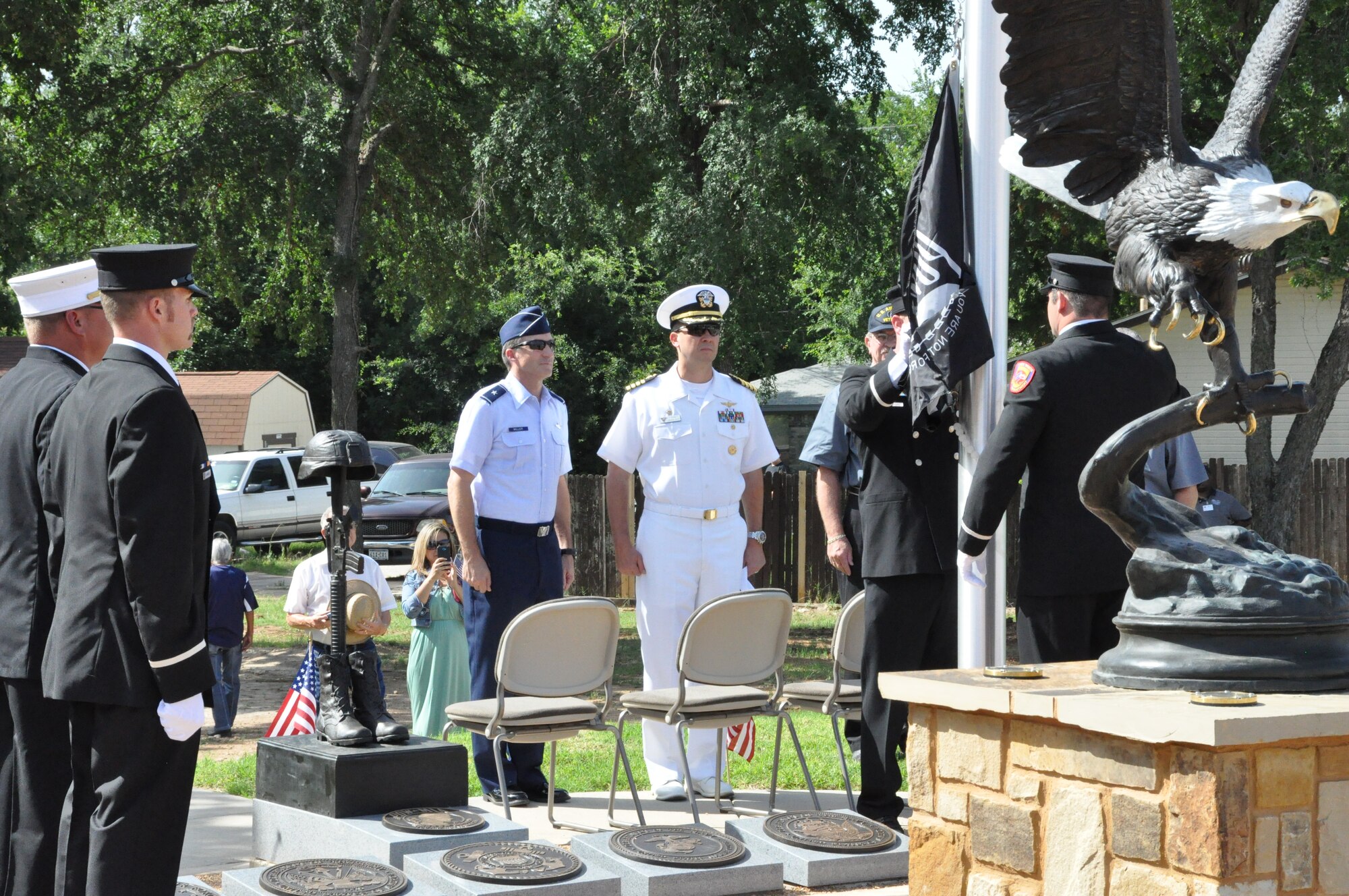 The Prisoner of War/Missing in Action flag is raised during the dedication ceremony of the Lake Worth Veterans Memorial Park Saturday, June 22. During the dedication both Capt. Robert A. Bennett, Naval Air Station Fort Worth Joint Reserve Base commander, and Brig. Gen. Ronald B. Miller, 301st Fighter Wing commander, spoke to attendees, in addition to city officials. The ceremony honored those who serve in the military, past and present. (U.S. Air Force photo by Senior Airman Melissa Harvey)