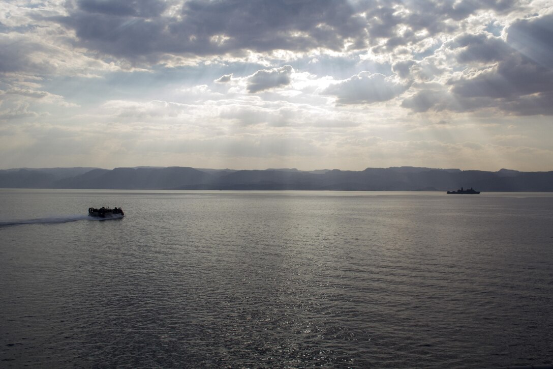 A U.S. Navy landing craft, air cushion (LCAC) assigned to Assault Craft Unit (ACU) 4 and the USS San Antonio (LPD 17), conduct embark operations wrapping up exercise Eager Lion 2013, Aqaba, Jordan, June 22, 2013. Exercise Eager Lion 2013 is an annual, multinational exercise designed to strengthen military-to-military relationships and enhance security and stability in the region by responding to modern-day security scenarios. The 26th MEU is a Marine Air-Ground Task Force forward-deployed to the U.S. 5th Fleet area of responsibility aboard the Kearsarge Amphibious Ready Group serving as a sea-based, expeditionary crisis response force capable of conducting amphibious operations across the full range of military operations. (U.S. Marine Corps photograph by Gunnery Sgt. Michael Kropiewnicki/26th MEU Combat Camera/Released) 