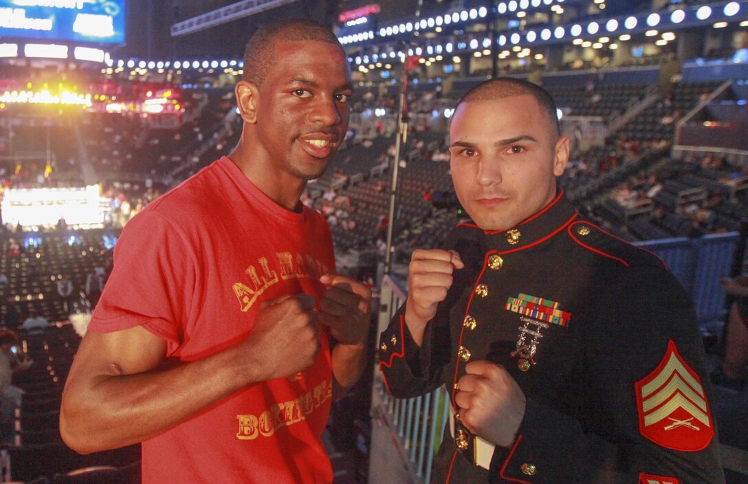 Jamel Herring, a Marine veteran from Coram, N.Y., poses for a photo with friend and former teammate Sgt. Todd DeKinderen, a recruiter with Recruiting Station New York, at Barclays Center, Brooklyn, N.Y., June 22.  During Herring’s time in the Corps he was a member of the All-Marine Boxing Team, which put him on the path that lead to his qualification to be on the Olympic boxing team.  (U.S. Marine Corps photo by Sgt. Caleb Gomez).