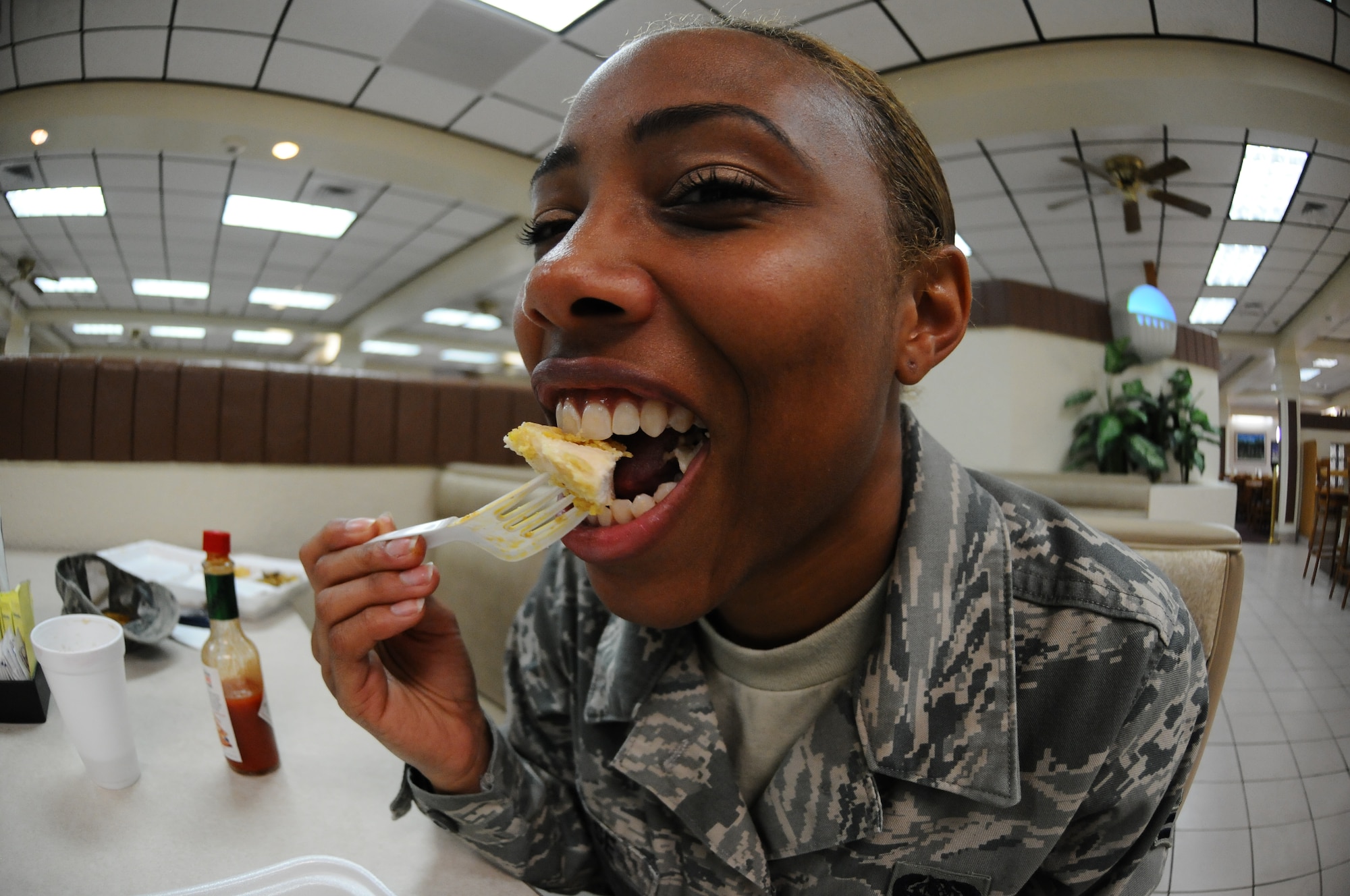 Airman 1st Class Michelle Chase, 36th Communications Squadron knowledge operations manager, takes a bite of Mr. Z’s Finger Lickin’ Baked Chicken June 21, 2013, on Andersen Air Force Base, Guam. Mr. Z’s chicken is a traditional Air Force recipe created by retired Chief Master Sgt. Robert J. Zahorchak. (U. S. Air Force photo by Airman 1st Class Emily A. Bradley/Released)