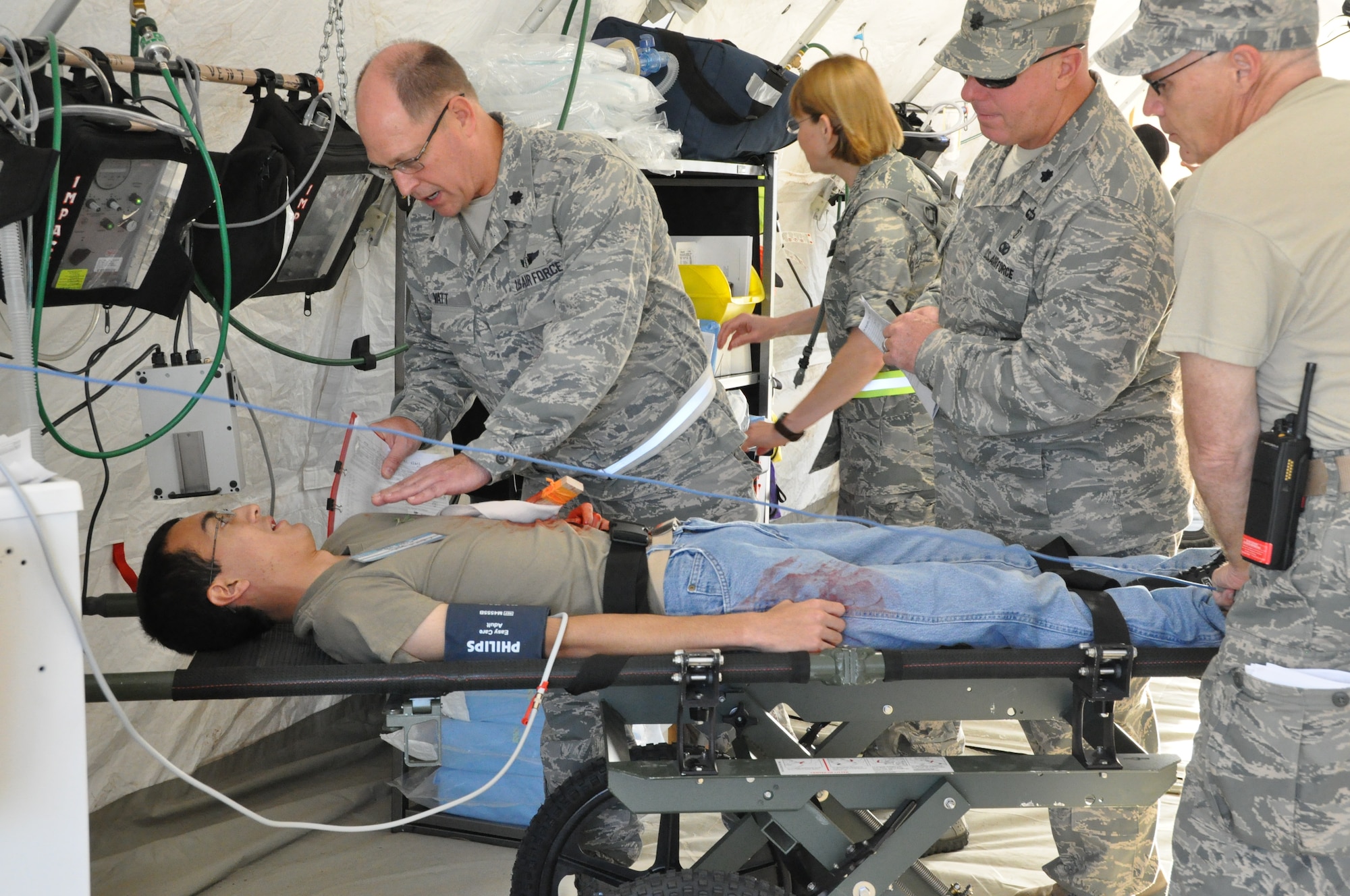 Medical personnel work on a patient during a Joint-Mass Casualty Exercise at Naval Air Station Fort Worth Joint Reserve Base, Texas, June 23. The exercise serves as a way for medical personnel to receive hands-on training. Members from the 301st Medical Squadron, 136th Medical Group, Navy personnel from the base, and cadets from local civil air patrol units particpated in the exercise. (U.S. Air Force photo by Senior Airman Melissa Harvey)
