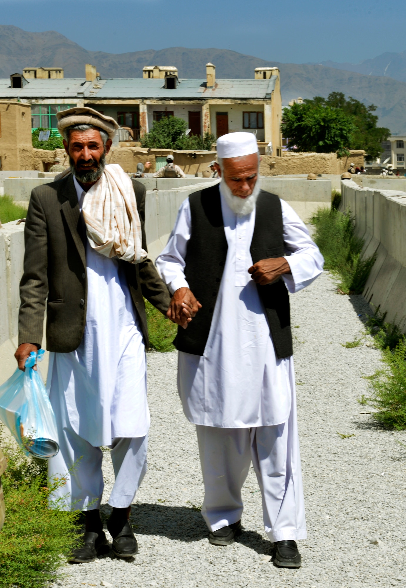 Two locals proceed to the Egyptian field hospital for treatment at Bagram Airfield, Afghanistan, June 22. The hospital has been closed for the last month for renovations. The hospital cares for Afghans as well as coalition service members supporting Operation Enduring Freedom. (U.S. Air Force photo/ Staff Sgt. Stephenie Wade)
