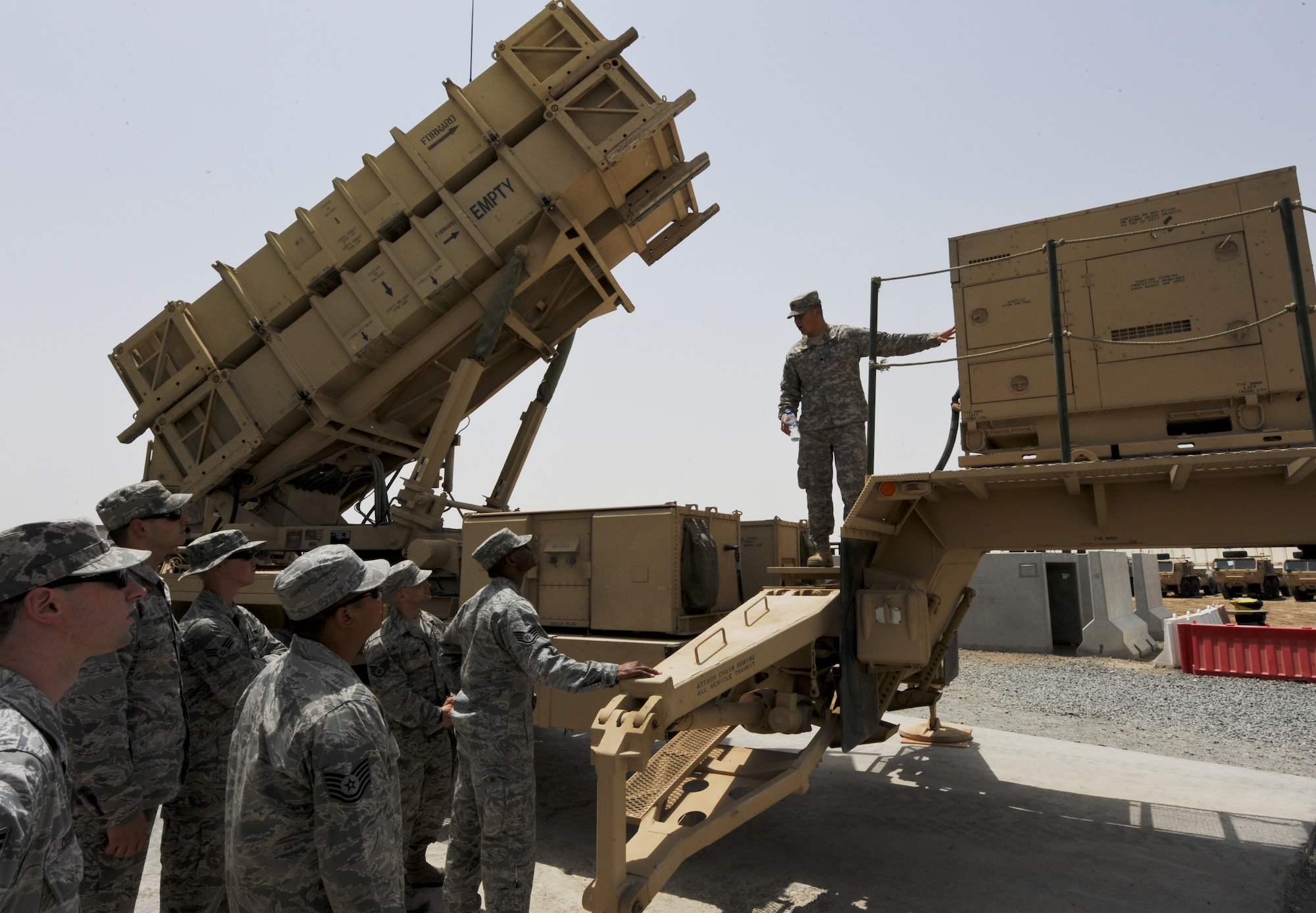U.S. Army Spc. Steven LaPointe, 1-62 Air Defense Artillery Battalion patriot launcher station enhanced operator/maintainer, shows members of the 380th Air Expeditionary Wing the generator of a guided missile launcher during a guided tour of a Patriot missile site at an undisclosed location in Southwest Asia June 14, 2013. The 1-62 ADA BN mission is to intercept tactical ballistic missiles in defense of the base, which is integrated into operations with the Air Force. The tour of the 1-62 ADA BN’s Patriot site was part of the Army’s 238th Birthday celebration. (U.S. Air Force photo by Senior Airman Jacob Morgan)