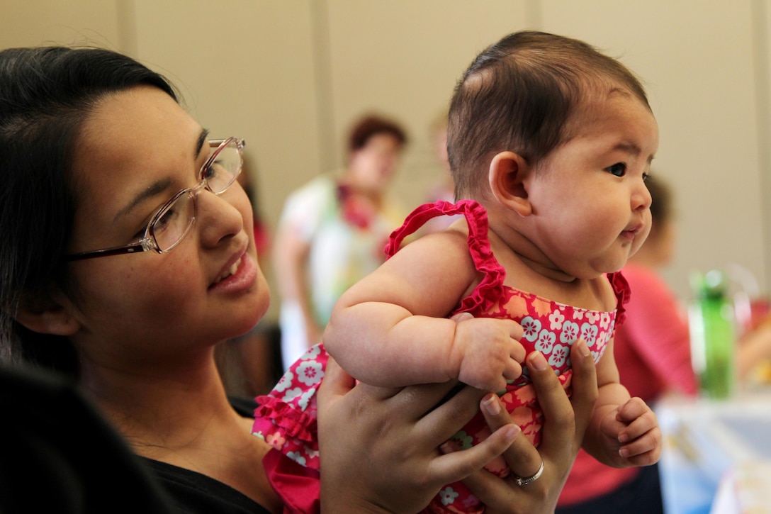 Mianne Mobley, 3rd CEB mom, holds her daughter Melody, 2 months, before the start of the 3rd CEB baby shower.