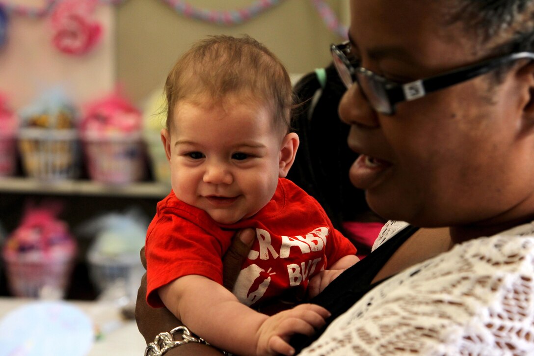 Jackson Pickles, 4 months, is held by Debra Willis, a Soldiers' Angels volunteer at the 3rd Combat Engineer Battalion Baby Shower, June 13, 2013.