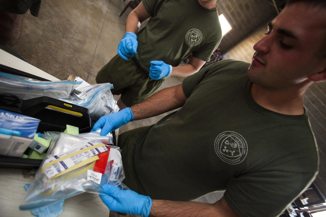 Lance Cpl. Steven Greenwood, 22nd Marine Expeditionary Unit chemical, biological, radiological and nuclear defense specialist and native of Saratoga Springs, N.Y., prepares his sampling equipment before hazardous material response training at the Guardian Centers in Perry, Ga., June 21, 2013. The Marines moved from room to room sampling different types of unknown chemical agents, applying the procedures and methods learned throughout the course. Eleven CBRN Marines attended the weeklong course, which was custom-tailored to the needs of the 22nd MEU and follows the CBRN Marines’ technical rescue training at the end of May. (Marine Corps photo by Sgt. Austin Hazard/Released)
