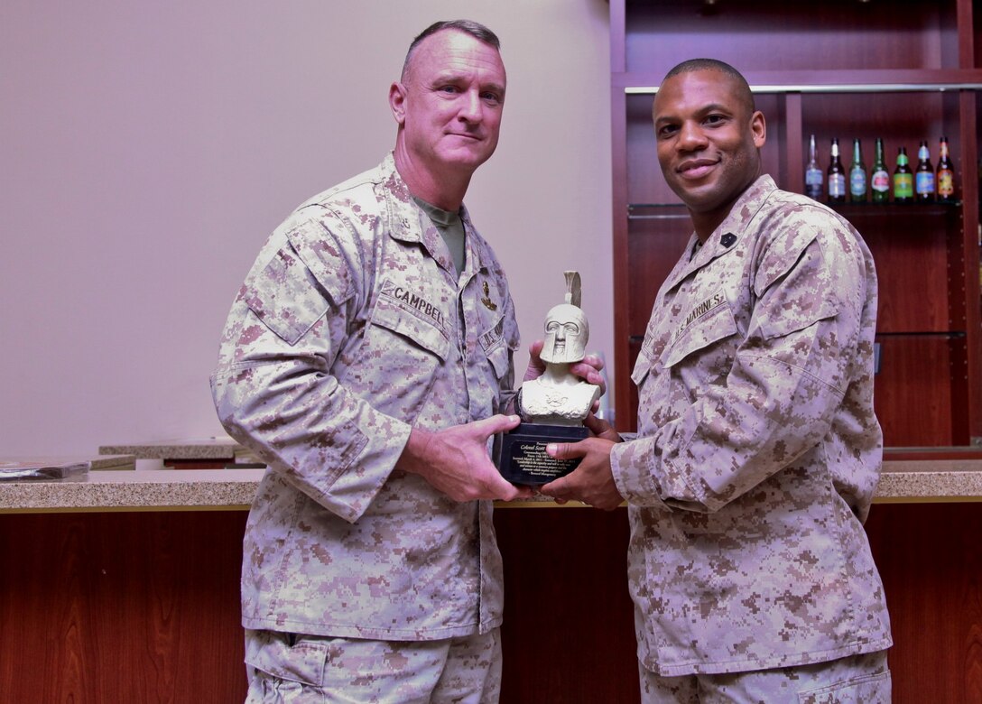 Sergeant Maj. John W. Scott, sergeant major, presents Col. Scott D. Campbell, commanding officer, both with the 15th Marine Expeditionary Unit, a gift from the unit’s staff non-commissioned officers during a farewell ceremony at the Pacific Views Events Center on Camp Pendleton, Calif., June 19. Campbell is slated to relinquish command later this month. (U.S. Marine Corps photo by Cpl. Emmanuel Ramos/Released)