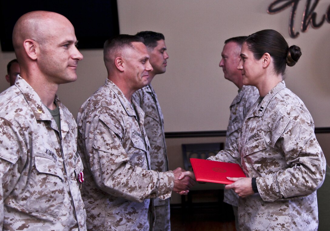 Maj. Brodie R. Carmichael, logistics officer, is congratulated on receiving a Meritorious Service Medal by Captain Janine Mills, adjutant, both with 15th Marine Expeditionary Unit, during an awards ceremony held at the Pacific View Events Center on Camp Pendleton, Calif., on June 19. Carmichael received the award for the superior performance of his duties as the logistics officer during two deployments with the MEU. Carmichael is from Yakima, Wash. (U.S. Marine Corps photo by Cpl. Emmanuel Ramos/Released)