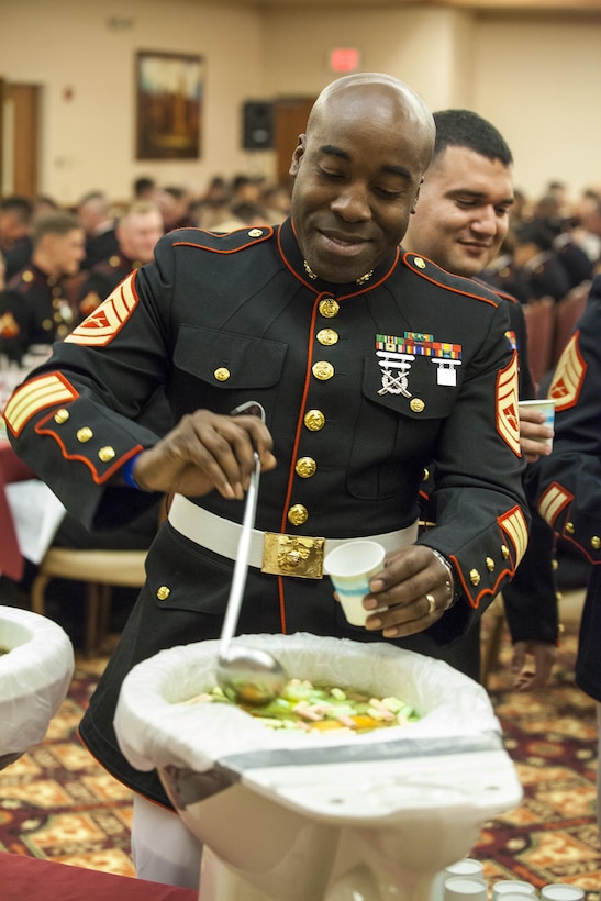 Marines of Marine Air Control Squadron 1 drink of the grog, a mysterious solution of unknown liquids, at the MACS-1 Mess Night on Marine Corps Air Station Yuma, Ariz., at the Sonoran Pueblo, June 7. The Mess Night is a Marine Corps tradition that brings a unit together for an evening of dining and camaraderie.