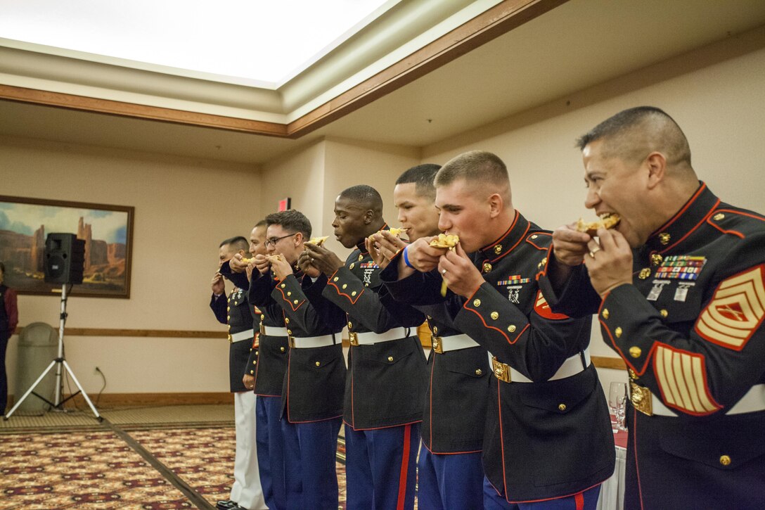 Marines of Marine Air Control Squadron 1 compete in an extra-pineapple pizza eating contest at the MACS-1 Mess Night on Marine Corps Air Station Yuma, Ariz., at the Sonoran Pueblo, June 7. The Mess Night is a Marine Corps tradition that brings a unit together for an evening of dining and camaraderie.