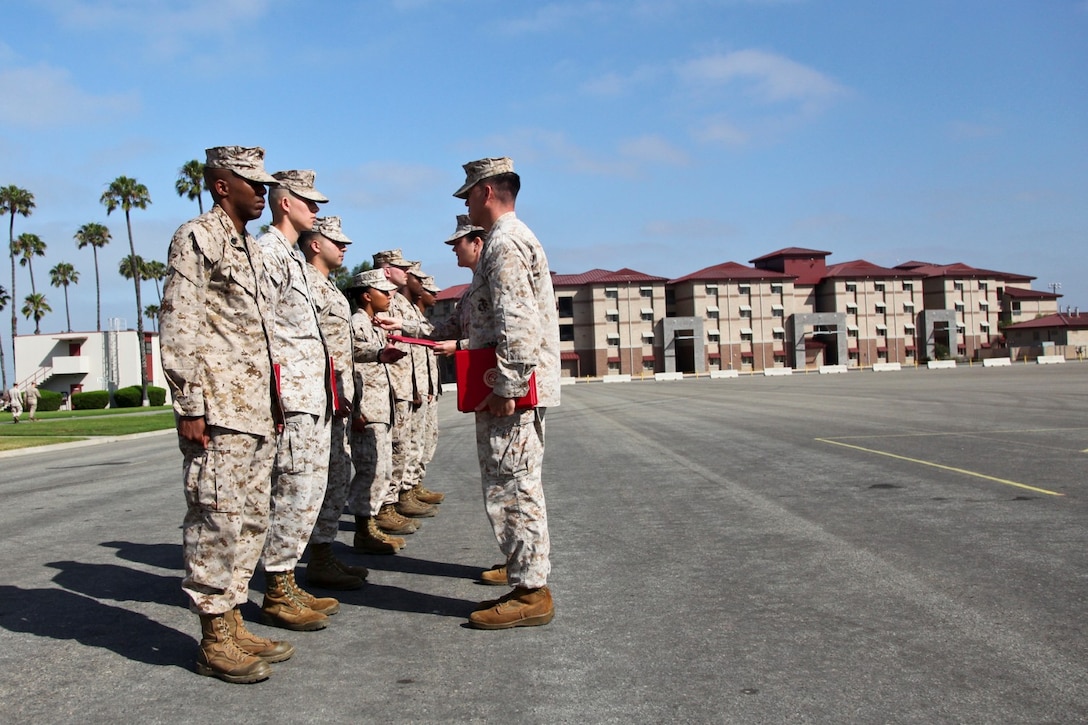 Marines with the Command Element, 15th Marine Expeditionary Unit, receive awards during an awards ceremony held on the Camp Del Mar Parade Deck, Camp Pendleton, Calif., June 17. The 15th MEU recently returned from a West Pac 12-2 deployment. (U.S. Marine Corps photo by Cpl. Emmanuel Ramos/Released)