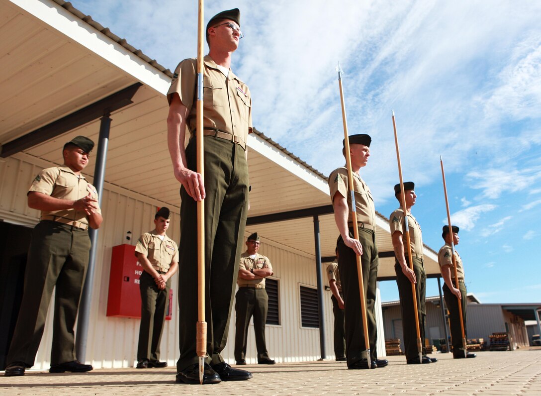 Marines with Lima Company, 3rd Battalion, 3rd Marine Regiment, Marine Rotational Force - Darwin, practice guidon manual movements during a Corporals Course, here, June 21. The course provides corporals with the education and skills necessary to lead Marines. Two Australian soldiers and a Navy corpsman enrolled in the course to further their Marine Corps knowledge.