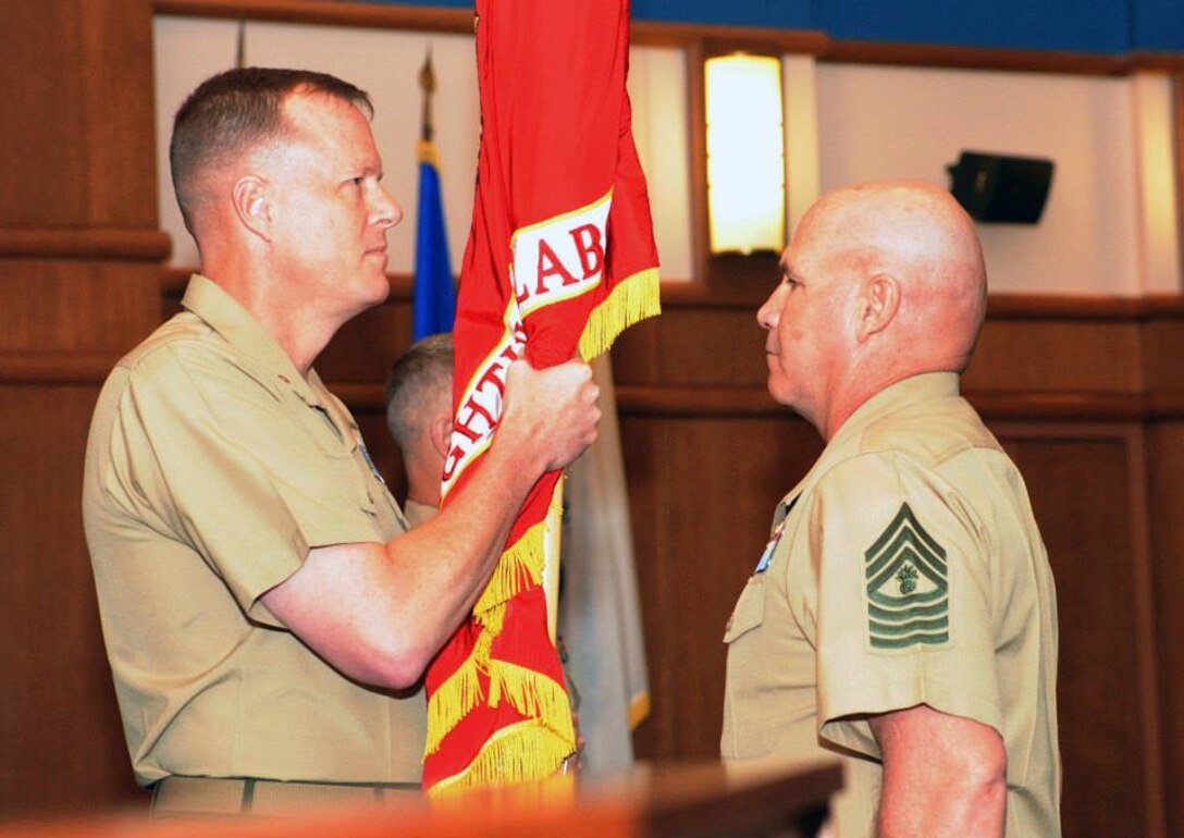 BGen Mark R. Wise (left) passes the Marine Corps Warfighting Lab’s colors to MGySgt. Larry E. Deyott as he relinquishes command of the Marine Corps Warfighting Laboratory at a change of command ceremony held at the Gray Research Center aboard Marine Corps Base Quantico.