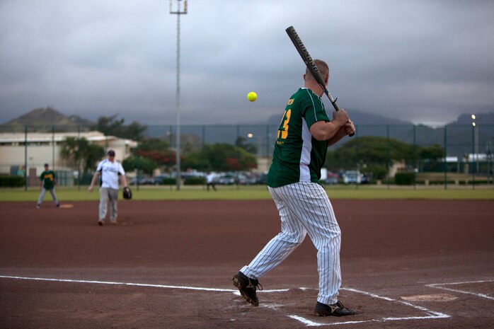 Marine Heavy Helicopter Squadron 463 pitcher Robert McCaleb prepares to swing at a pitch made by Headquarters Battalion pitcher Rob Hosey during an intramural softball game at Annex Field, June 13, 2013. (U.S. Marine Corps photo by Lance Cpl. Suzanna Lapi)