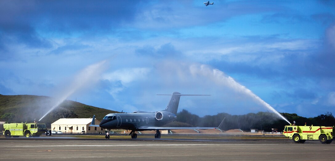 The Marine Corps' only C20G, named “The Ghost,” drives through a “welcome home” water shower supplied by a pair of Aircraft, Rescue and Firefighting vehicles during its homecoming flight at Marine Corps Air Station Kaneohe Bay, June 13, 2013. The aircraft was welcomed with a homecoming party provided by the unit to celebrate the jet’s return. Service members and their families were able to board “The Ghost” to view its interior. (U.S. Marine Corps photo by Lance Cpl. Matthew Bragg)