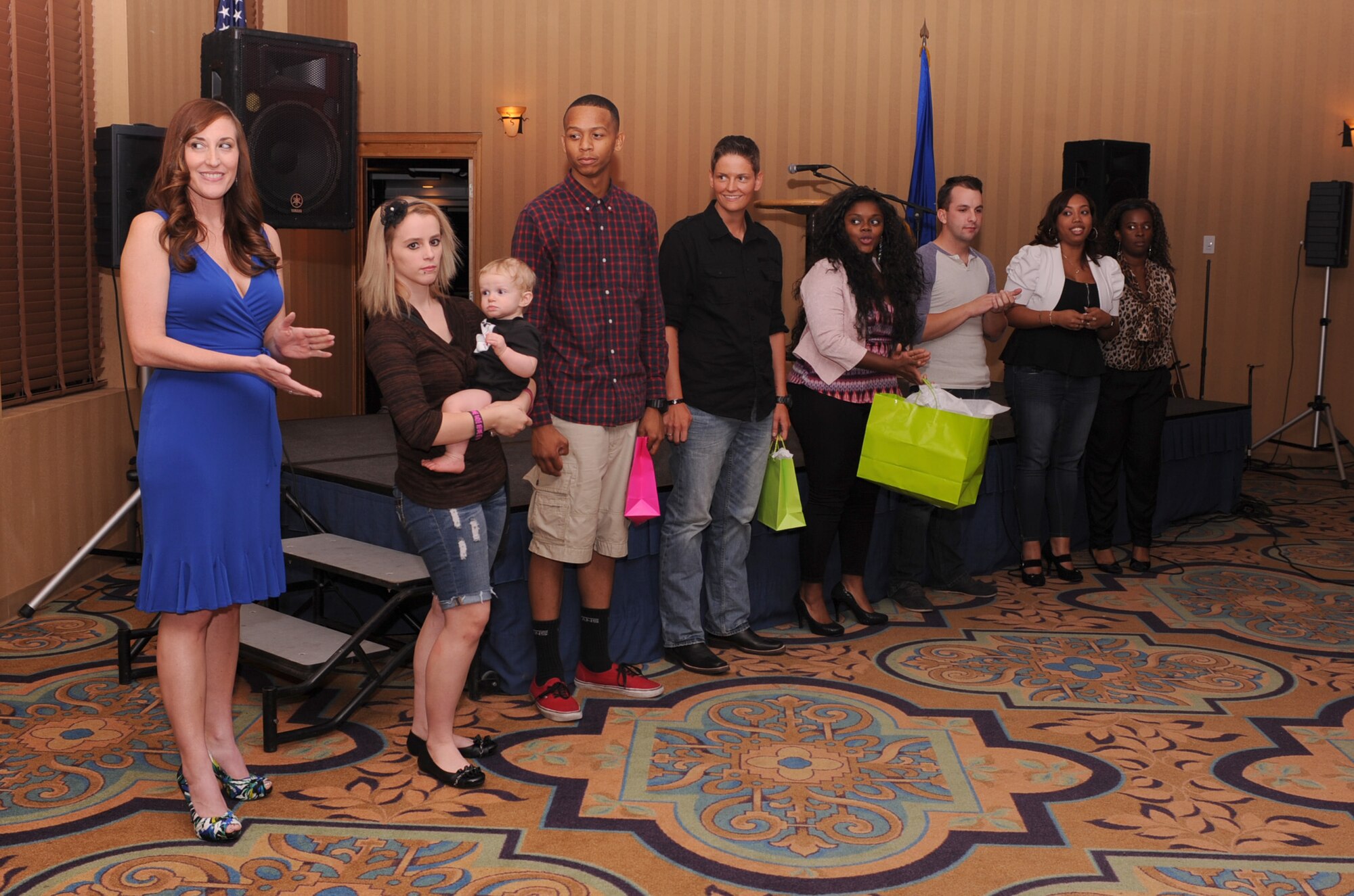 U.S. Air Force Airmen and spouses line up after performing for D-M’s Got Talent to be congratulated for their performances at Davis-Monthan Air Force Base, Ariz., June 20, 2013. D-M’s got Talent gives members of the Desert Lightning Team the opportunity to highlight their talents as well as build morale. (U.S. Air Force photo by Senior Airman Christine Griffiths/Released)