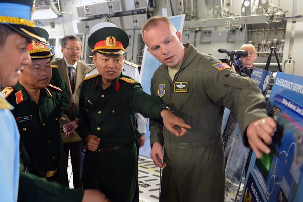 Lt. Col. Brent Keenan, 62nd Operations Group deputy commander, describes the capabilities of the C-17 Globemaster III aircraft to Senior Lt. Gen. Do Ba Ty, Vietnam People’s Army Chief of the General Staff and Socialist Republic of Vietnam Vice Minister of the National Defense, and other Vietnamese military officials during a tour June 19, 2013 at Joint Base Lewis-McChord, Wash. Keenan explained the C-17's capabilities when performing missions in Antarctica. (U.S. Air Force photo/Airman 1st Class Jacob Jimenez)