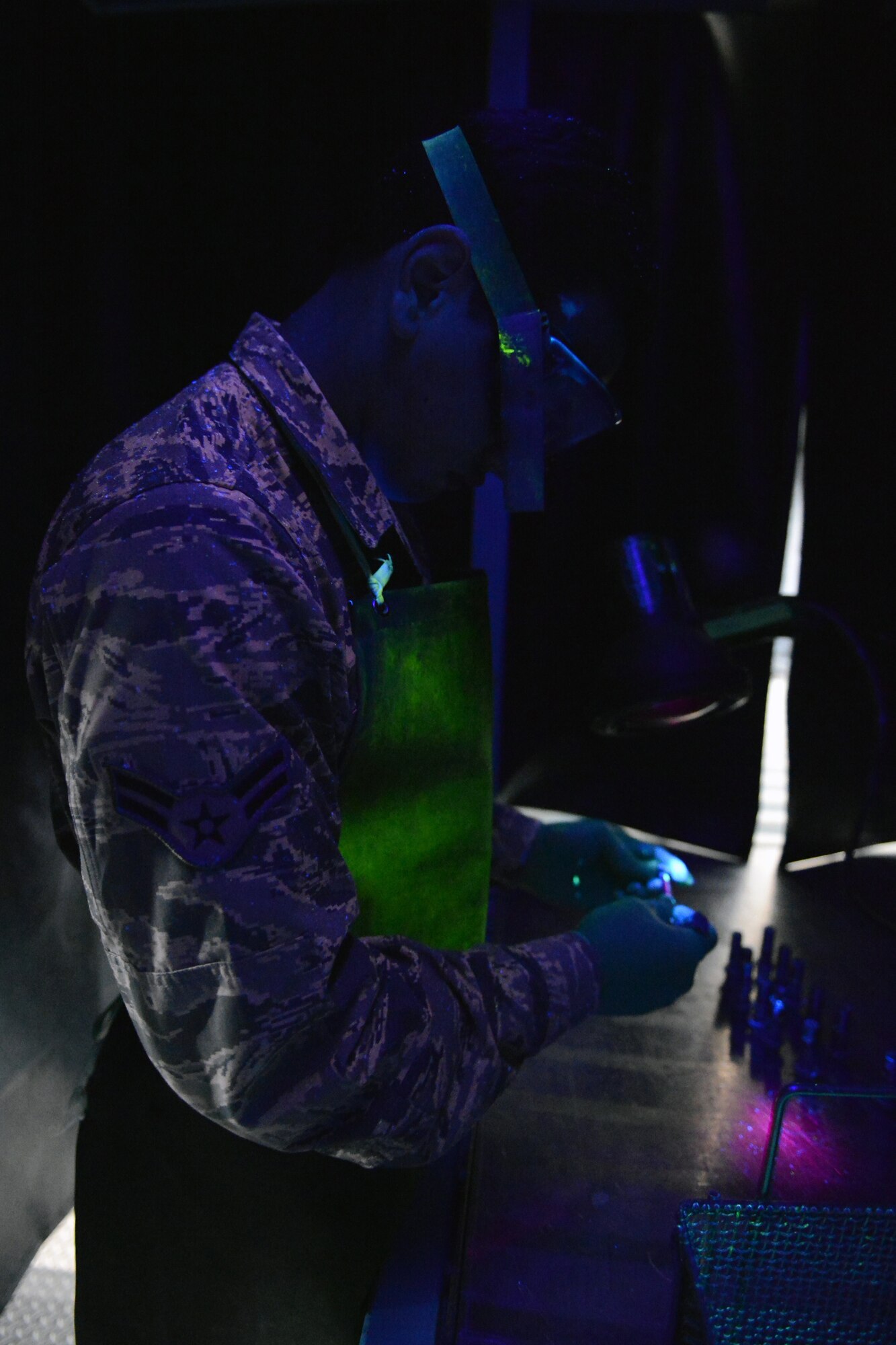 Airman 1st Class Garee Gregory, 62nd Maintenance Squadron nondestructive inspection technician, inspects a bolt under a black light during a penetrant inspection June 18, 2013 at Joint Base Lewis-McChord, Wash. Nondestructive inspection personnel are responsible for inspecting hardware and equipment using magnetic particle, eddy current, dye penetrant and X-ray inspections, to detect material deficiencies such as cracks and gouges. (U.S. Air Force photo/Airman 1st Class Jacob Jimenez)