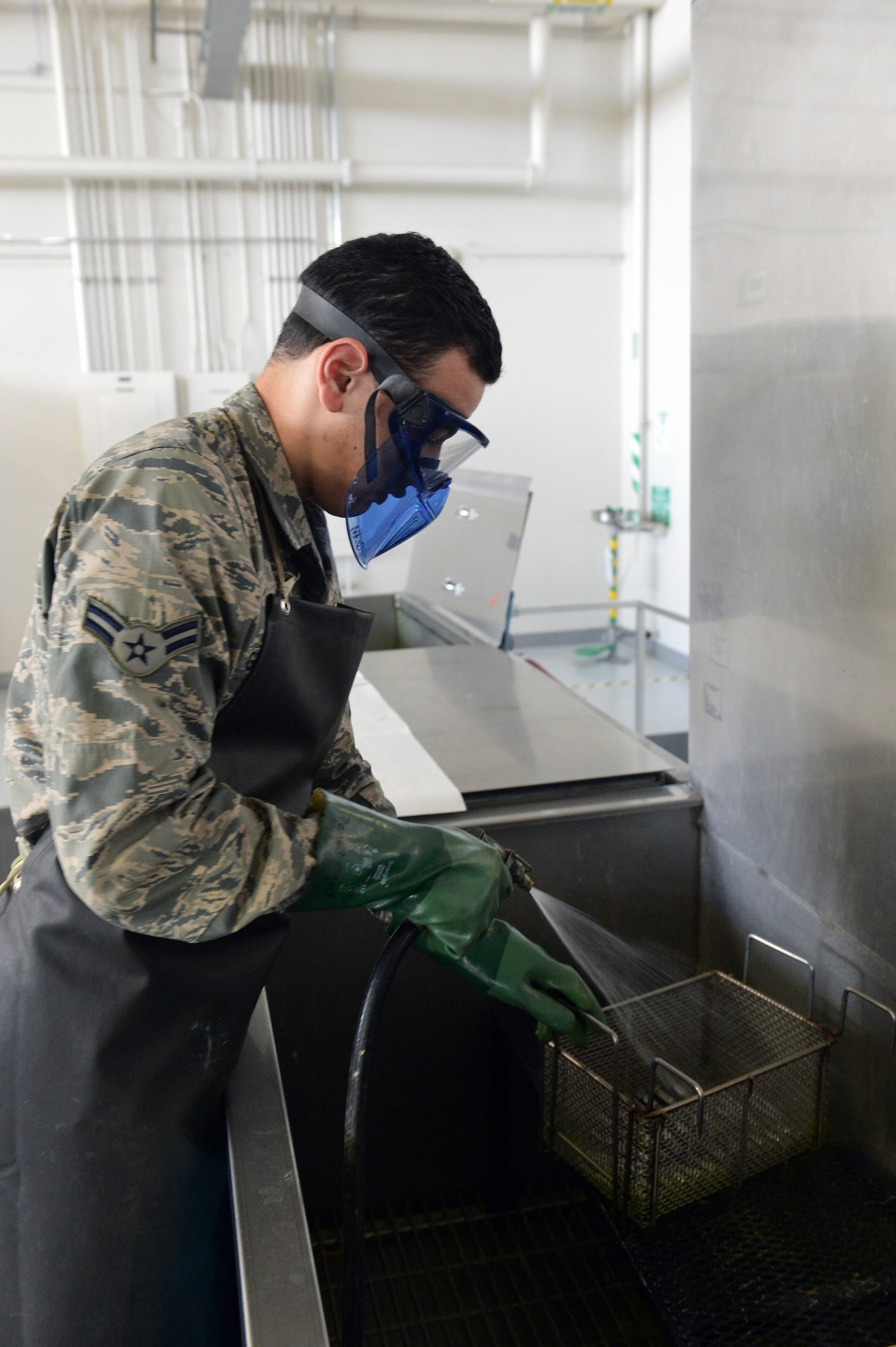 Airman 1st Class Garee Gregory, 62nd Maintenance Squadron nondestructive inspection technician, rinses bolts used on a C-17 Globemaster III aircraft braking system during a penetrant inspection June 18, 2013 at Joint Base Lewis-McChord, Wash. The penetrant inspection is used to detect possible defects or damage in hardware or equipment that cannot be seen with the naked eye. (U.S. Air Force photo/Airman 1st Class Jacob Jimenez)