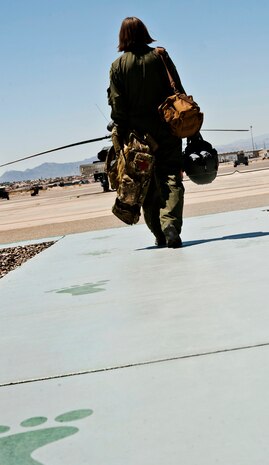 Airman 1st Class Natasha Libby, 66th Rescue Squadron aerial gunner, walks to the helicopter pad June 20, 2013, at Nellis Air Force Base, Nev. Being the only female gunner in the 66th RQS, Libby doesn’t see herself as any different than any other gunner. (U.S. Air Force photo by Senior Airman Daniel Hughes)