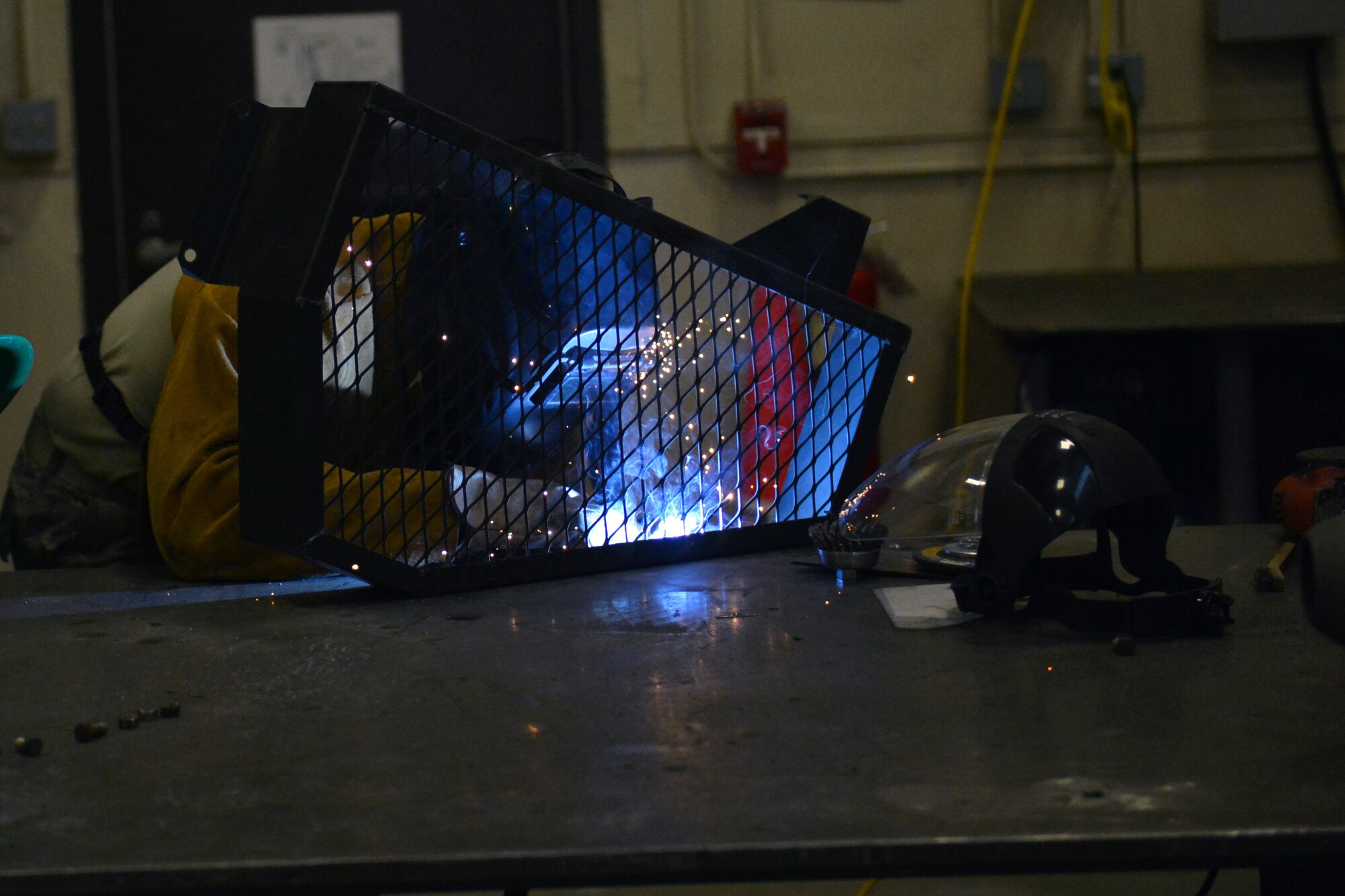 Airman 1st Class Angel Laureano Pinero, 62nd Maintenance Squadron metals technology apprentice, welds a cover screen from a piece of aerospace ground equipment June 17, 2013 at Joint Base Lewis-McChord, Wash. Metals technology utilizes more than 30 different machines to complete their mission at JBLM. (U.S. Air Force photo/Airman 1st Class Jacob Jimenez)   