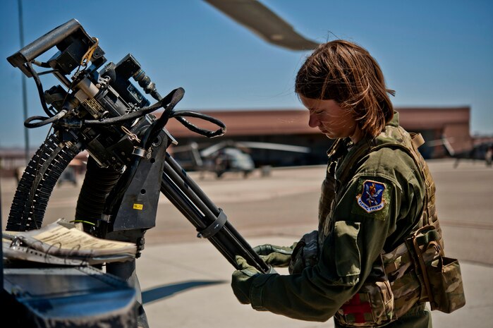 Airman 1st Class Natasha Libby, 66th Rescue Squadron aerial gunner, examines the barrels of a Gau-2 mini gun mounted on an HH-60 Pave Hawk helicopter June 20, 2013, at Nellis Air Force Base, Nev. Libby must inspect each part of the weapons systems on the HH-60 Pave Hawk to ensure safety and proper function. (U.S. Air Force photo by Senior Airman Daniel Hughes)