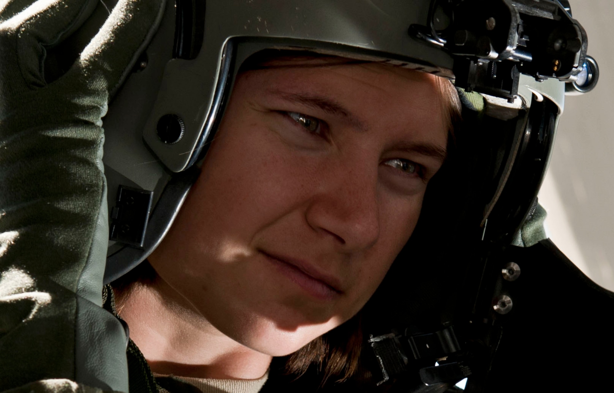 Airman 1st Class Natasha Libby, 66th Rescue Squadron aerial gunner, dons her flight helmet June 20, 2013, at Nellis Air Force Base, Nev. Aircrew helmets not only protect from injury, but provide critical communication capabilities as well. (U.S. Air Force photo by Senior Airman Daniel Hughes)