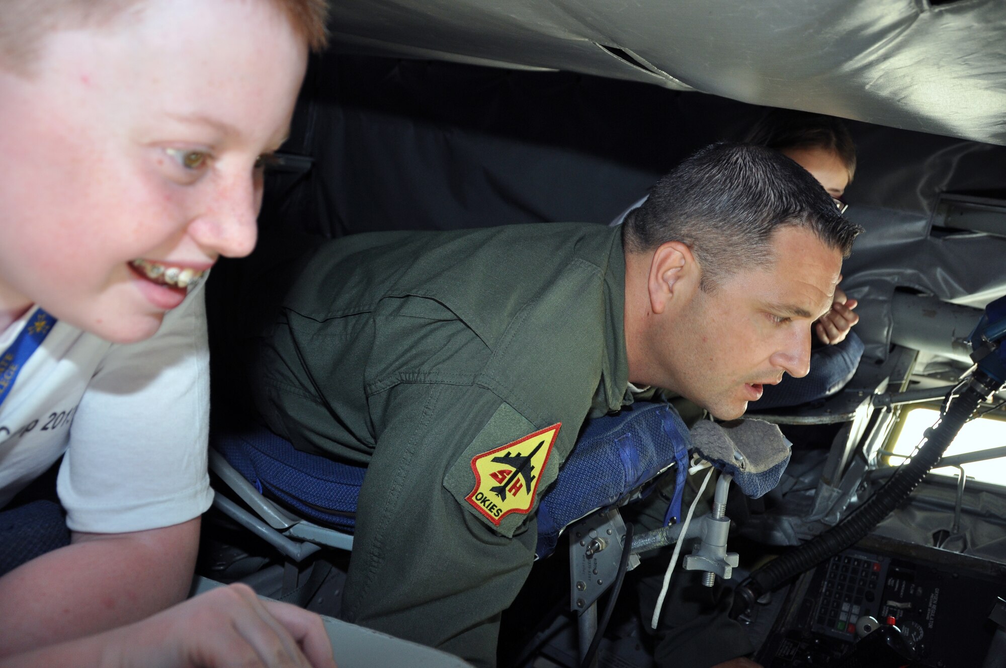Hunter Wood looks out the back of a KC-135 Stratotanker as Master Sgt. Jeff Bass, 465th Air Refueling Squadron boom operator explains the aerial refueling process.  Wood is a member of the Charles B. Hall Chapter of Tuskegee Airmen in Oklahoma City.  The members spent four days of camp at Tinker AFB recently as they learned about rocket building and launching, Tuskegee Airmen history and science and classes in aviation and science careers.  Tours were also given to the group at the Federal Aviation Administration facility and the KC-135 Stratotanker.  According to Mahlon Smith, vice-president of the Charles B. Hall chapter of Tuskegee Airmen Incorporated in Oklahoma City, this camp is the first for this group and was in the planning stages for seven months.  (U.S. Air Force photo/Senior Airman Mark Hybers)