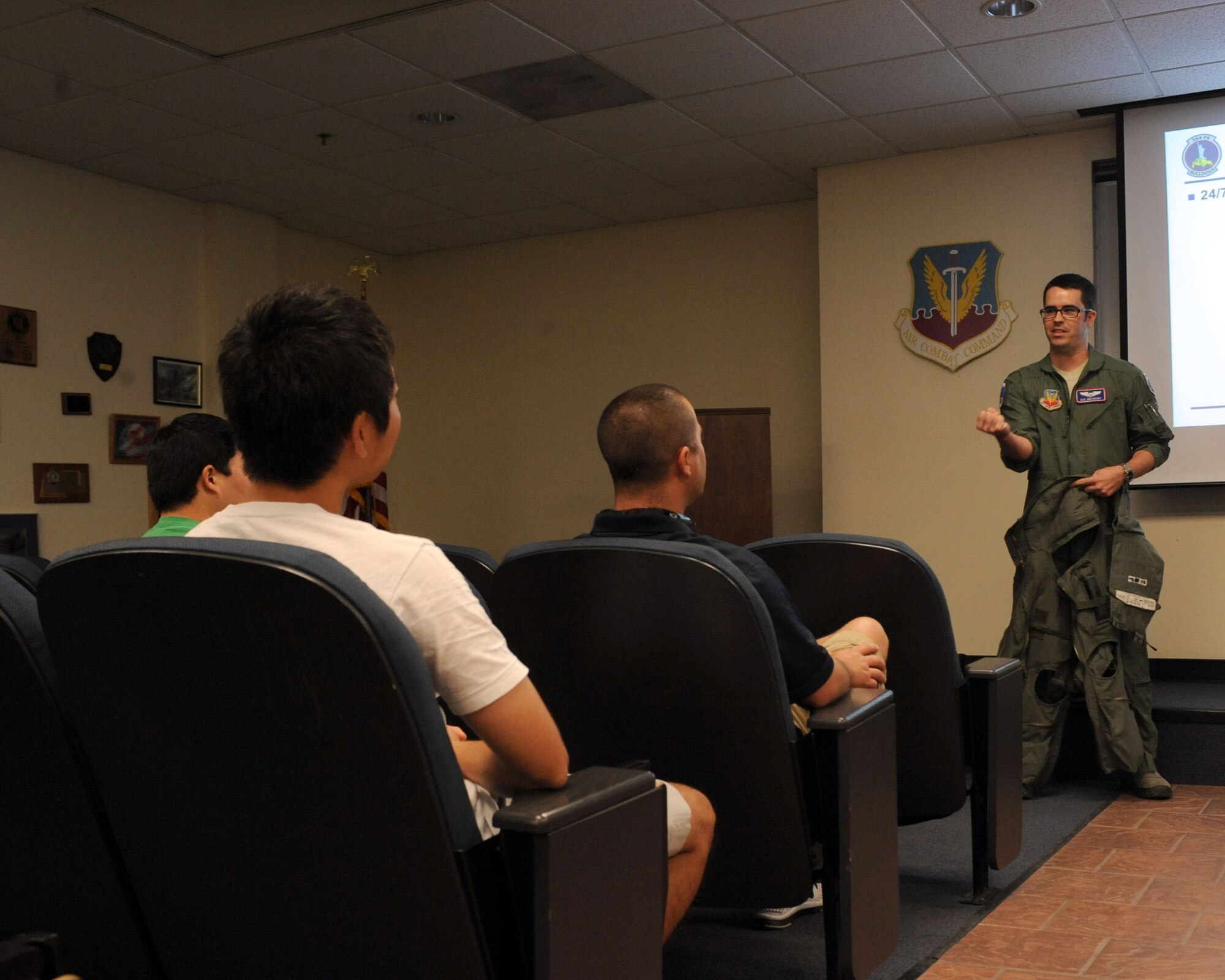 U.S. Air Force Capt. Matthew Orlovsky, 354th Fighter Squadron, displays some of the equipment to members of the Tucson Padres at Davis-Monthan Air Force Base, Ariz., June 6, 2013. The Padres scheduled a visit, via Mike Feder, Tucson Padres general manager and 354th FS honororay commander, to learn more about the 354th FS’ mission. (U.S. Air Force photo by Senior Airman Timothy Moore/Released)