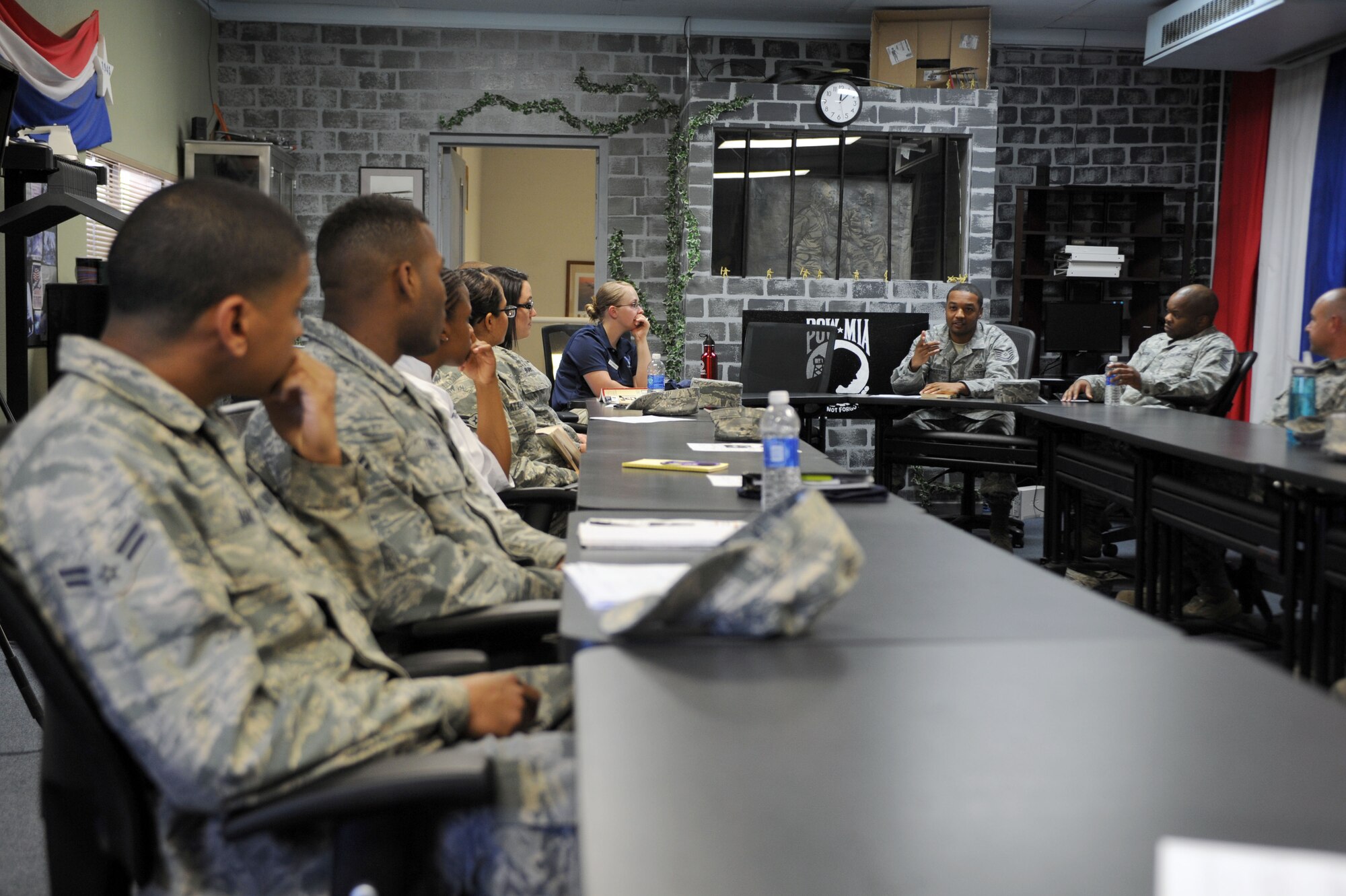 U.S. Air Force Tech. Sgt. Lorenzo Livingston, Airman Leadership School instructor, speaks to Airmen, noncommissioned officers, senior NCOs and officers during a Leaders Are Readers meeting at Davis-Monthan Air Force Base, Ariz., June 19, 2013. Livingston and Tech. Sgt. Steve McIntyre, 355th Medical Operations Squadron Mental Health Element noncommissioned officer in charge, founded LAR as a means to give junior enlisted Airmen an avenue to talk and learn from higher leadership in a more direct way. (U.S. Air Force photo by Senior Airman Timothy Moore/Released)