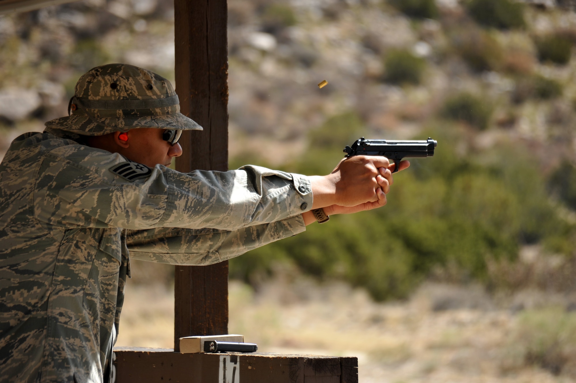 An Airman fires at a target at during a May 17 shooting competition at Coyote Canyon. Anyone purchasing firearms at the new Exchange should know the rules for transporting and safeguarding weapons on base. (File photo by Ken Moore)