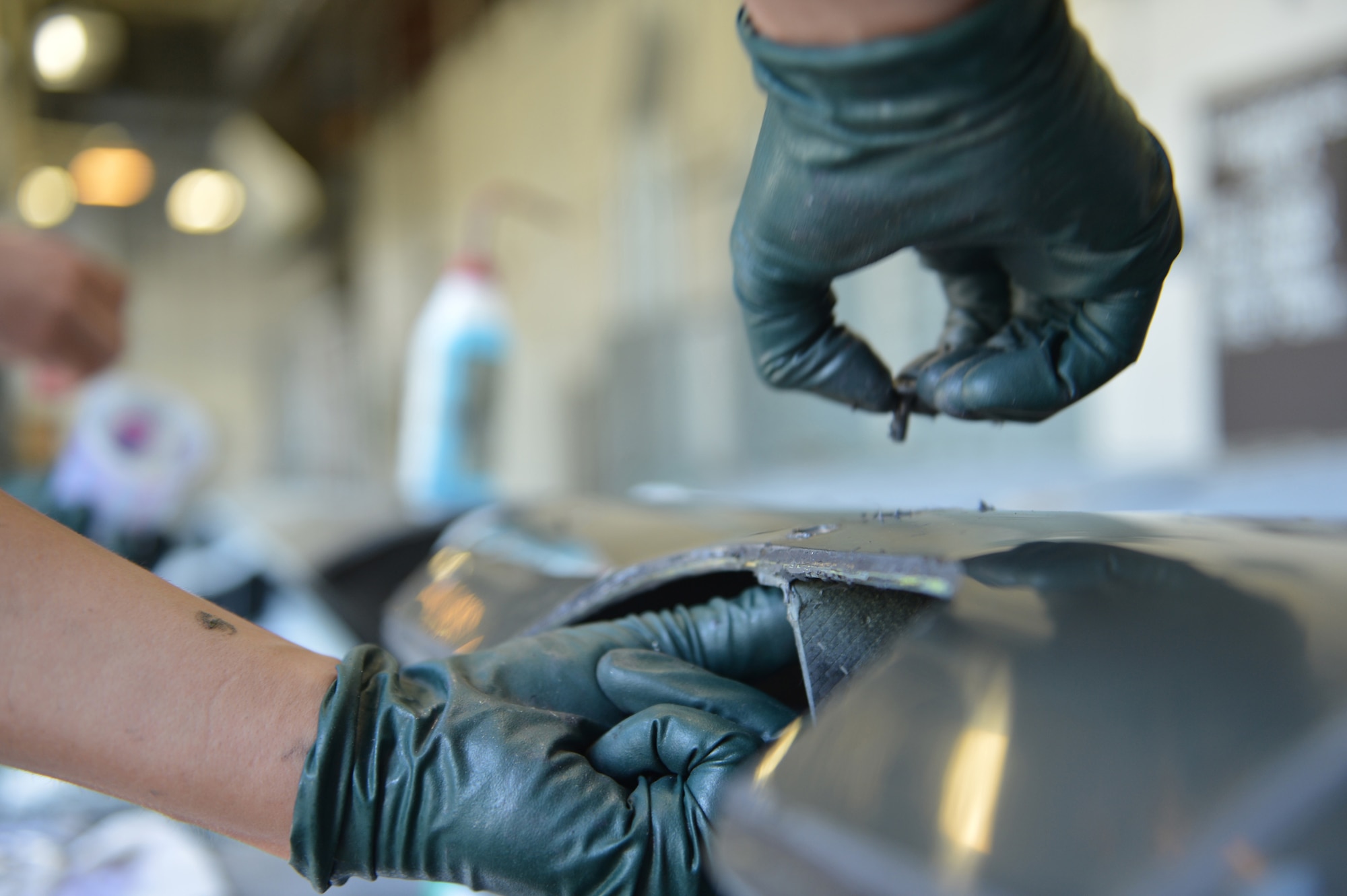 Senior Airman Justin Zirwes, 446th Maintenance Squadron structural maintenance technician, fastens a repaired rub strip to part of a wing from a C-17 Globemaster III aircraft May 13, 2013 at Joint Base Lewis-McChord, Wash. Each screw applied must first be coated in a sealant to prevent corrosion. (U.S. Air Force photo/Airman 1st Class Jacob Jimenez)