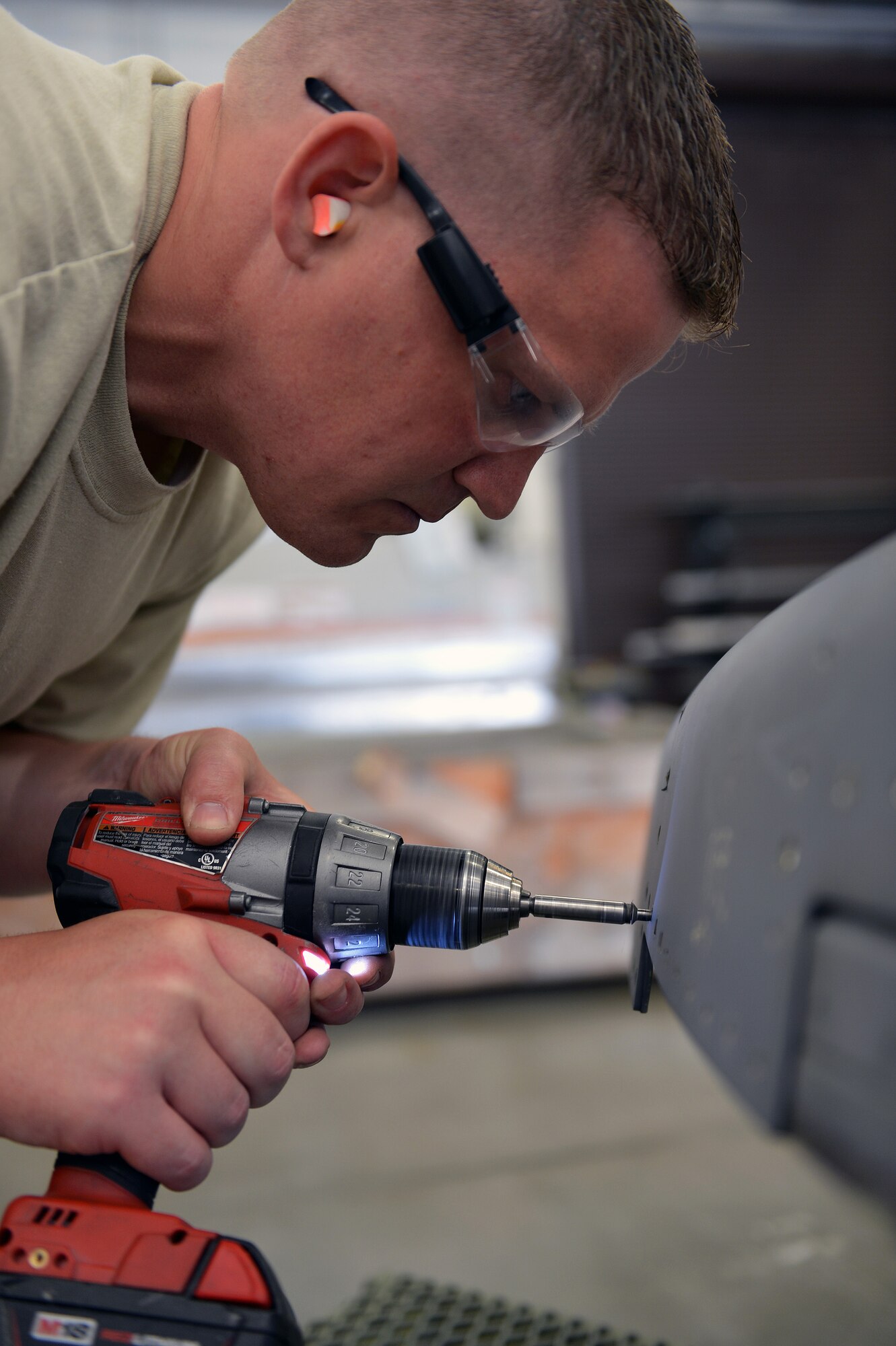 Staff Sgt. Tobias Abernathy, 62nd Maintenance Squadron structural maintenance technician, drills rivets out from a thrust reverser to repair a cracked cover plate May 13, 2013 at Joint Base Lewis-McChord, Wash. The C-17 Globemaster III aircraft thrust reversers are used to decelerate the aircraft when landing. (U.S. Air Force photo/Airman 1st Class Jacob Jimenez)