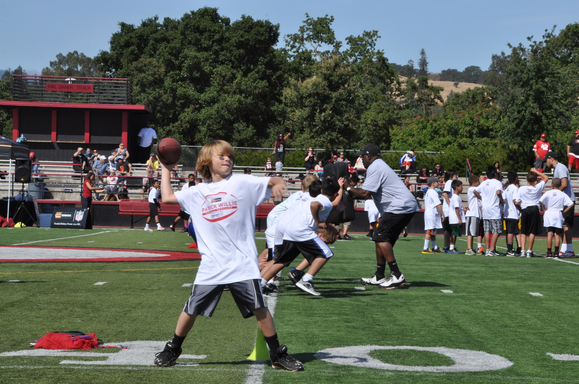 A child sets up to throw a pass. Learning how to drop back and set up to pass is key for any quarterback. (U.S. Air Force photo/Staff Sgt. Christopher Carranza)