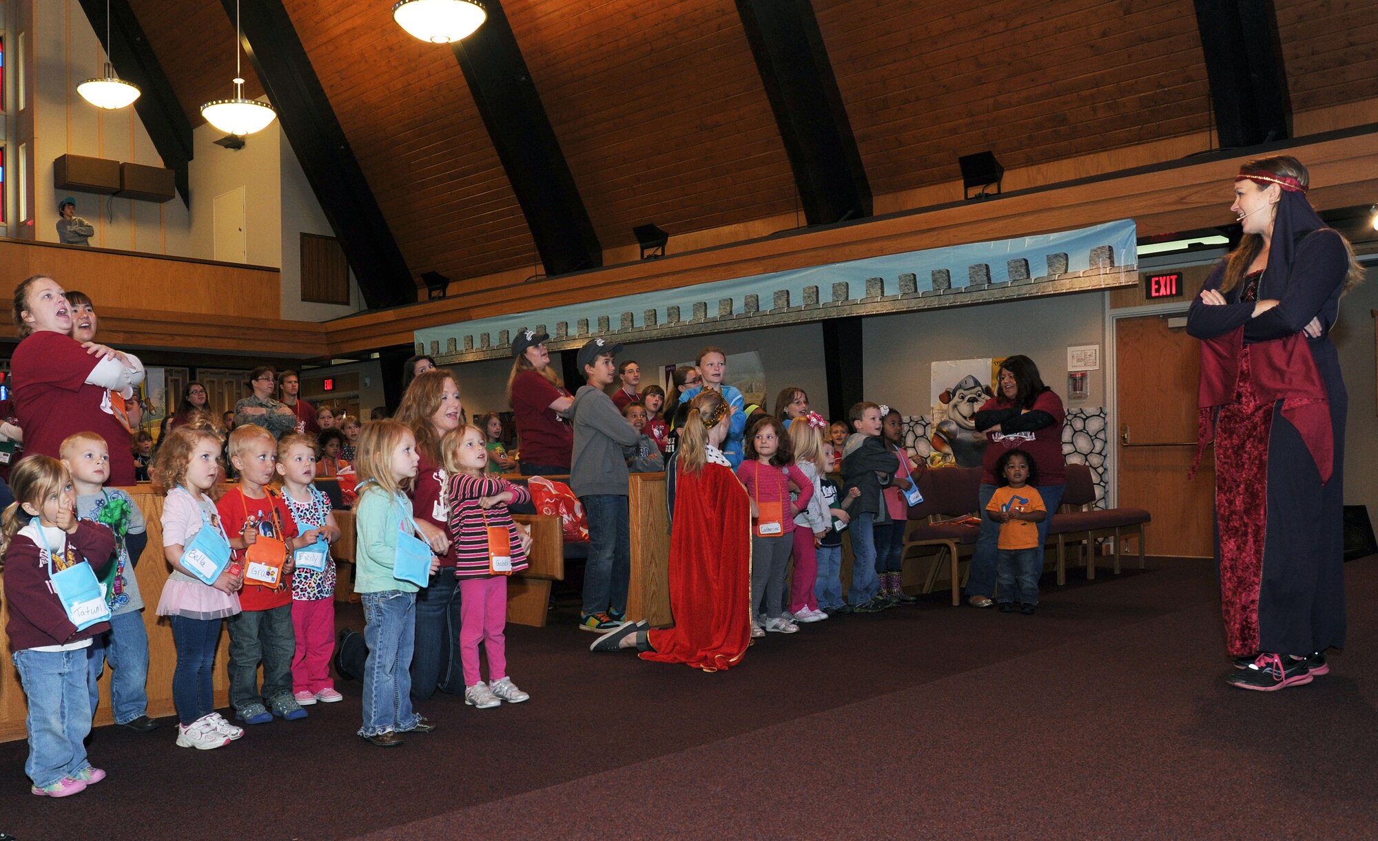 Julie Pillard, sing and play rock leader, sings with the children during the Summer Vacation Bible School at Fairchild Air Force Base, Wash., June 20, 2013. Summer Vacation Bible School is a five day session where kids learn how to sing, praise and meet new friends. (U.S. Air Force photo by Airman 1st Class Janelle Patiño/Released)