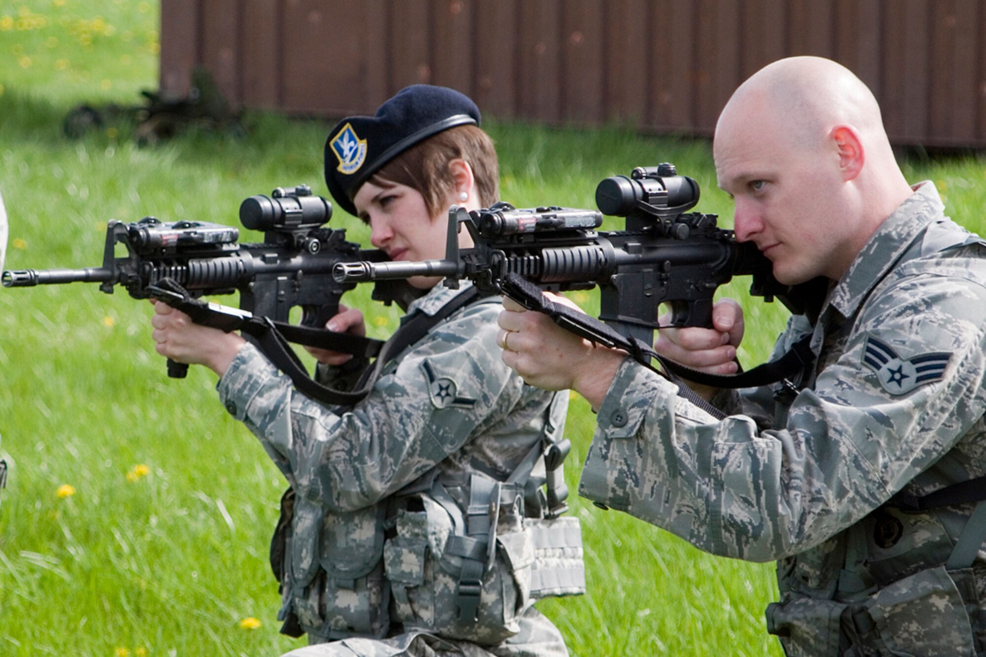 Senior Airman Dominic Bichler, right, and Airman Brittany Chapman, 434th Security Forces Squadron fire team members, take aim with M-4 rifles during weapons training at Grissom Air Reserve Base, Ind., May 5, 2013. During the training, 434th SFS members practiced tactical movements and weapon transition drills. (U.S. Air Force photo/Staff Sgt. Andrew McLaughlin) 
