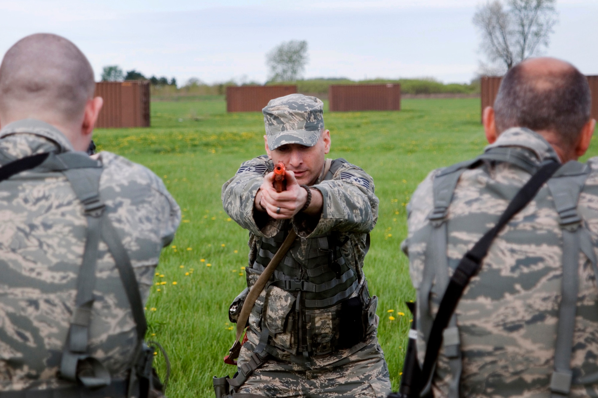 Tech. Sgt. Alexander Harris, 434th Security Forces Squadron squad leader, demonstrates the proper form for quickly switching from an M-4 rifle to an M-9 pistol during weapons training at Grissom Air Reserve Base, Ind., May 5, 2013. During the training, 434th SFS members practiced tactical movements and weapon transition drills. (U.S. Air Force photo/Staff Sgt. Andrew McLaughlin)