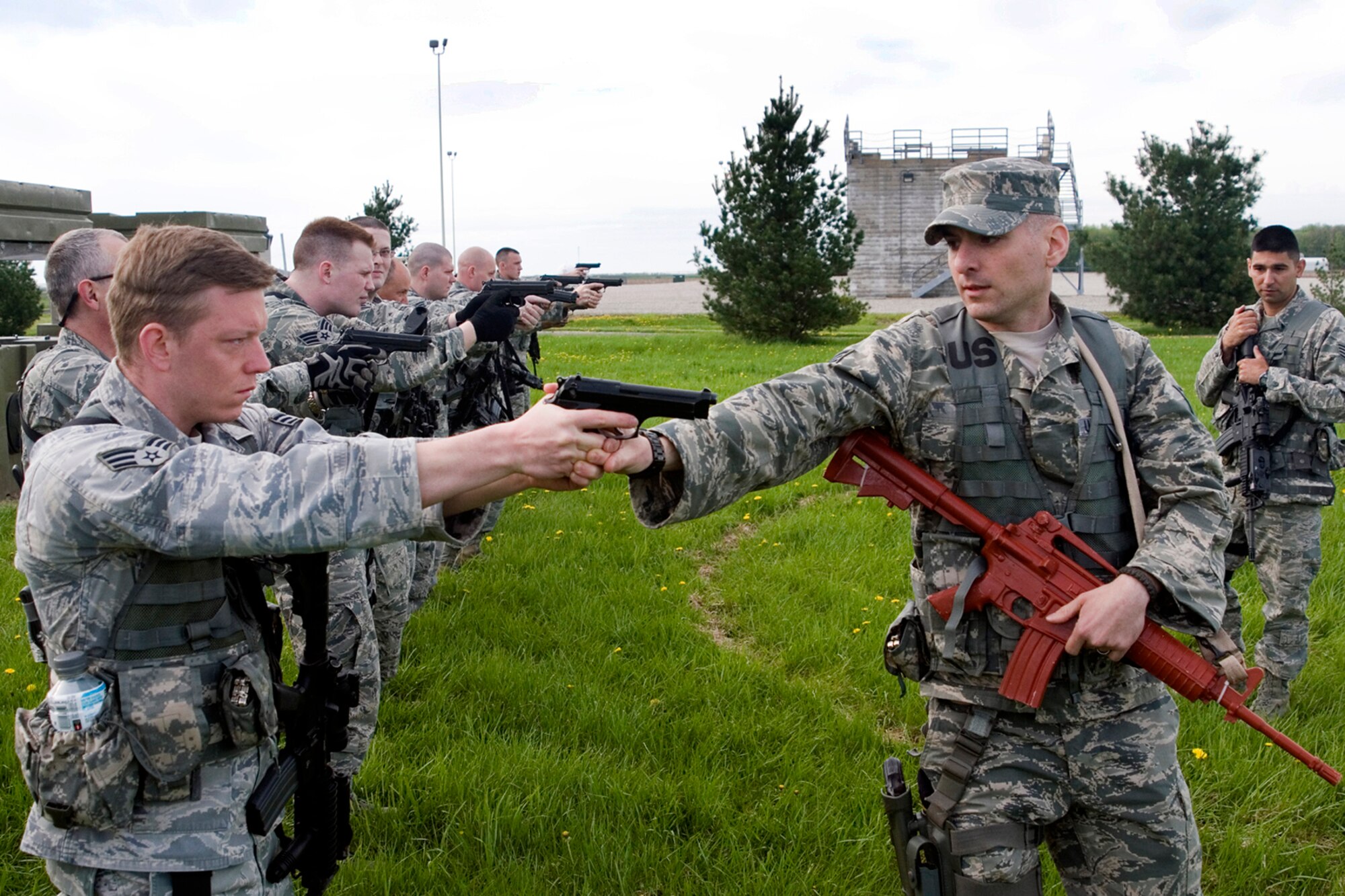 Tech. Sgt. Alexander Harris, 434th Security Forces Squadron squad leader, inspects an Airman's form during weapons training at Grissom Air Reserve Base, Ind., May 5, 2013. During the training, 434th SFS members practiced handling their weapons effectively in response to threats. (U.S. Air Force photo/Staff Sgt. Andrew McLaughlin)