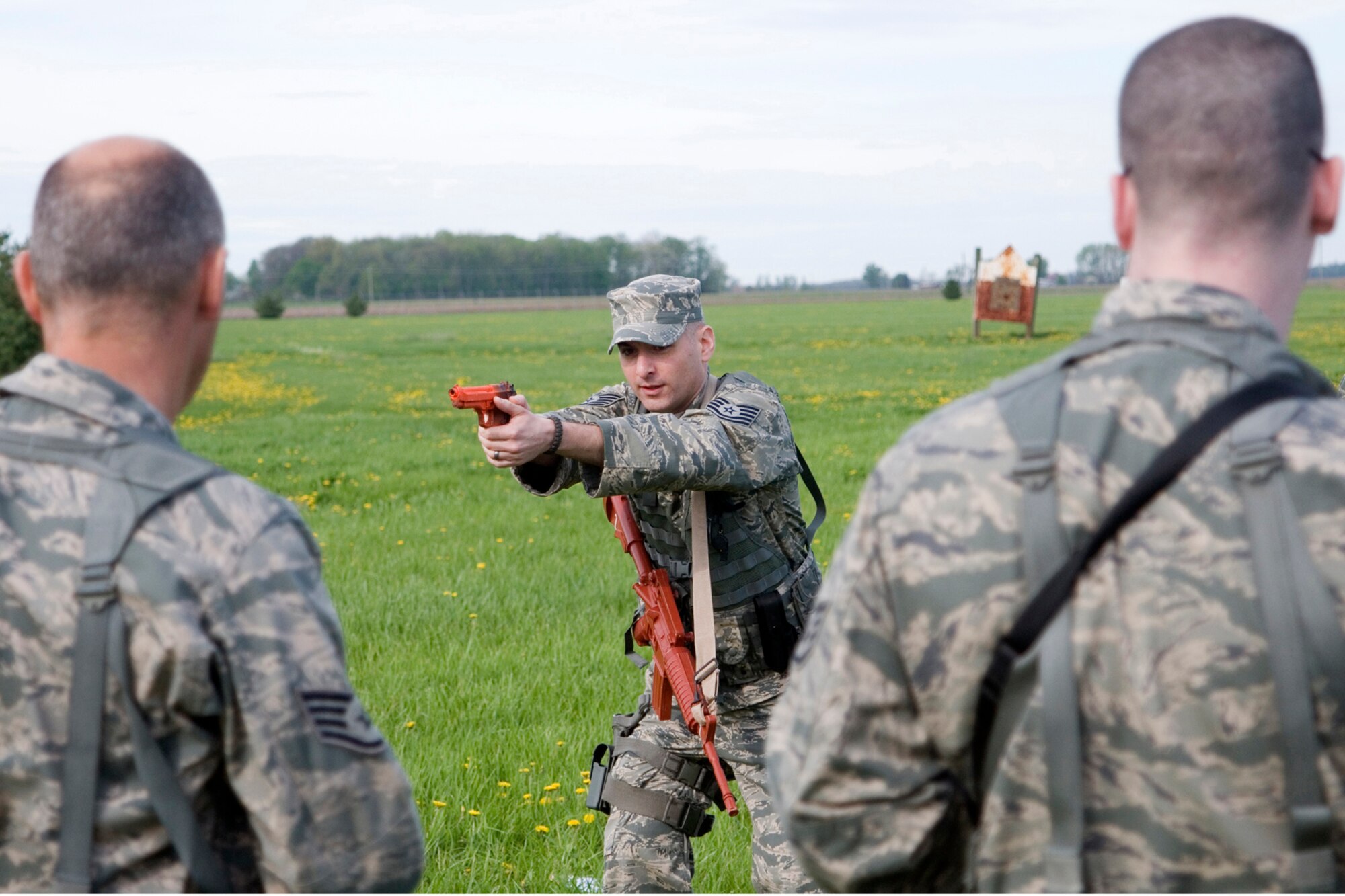 Tech. Sgt. Alexander Harris, 434th Security Forces Squadron squad leader, demonstrates the proper form for quickly switching from an M-4 rifle to an M-9 pistol during weapons training at Grissom Air Reserve Base, Ind., May 5, 2013. During the training, 434th SFS members practiced tactical movements and weapon transition drills. (U.S. Air Force photo/Staff Sgt. Andrew McLaughlin)
