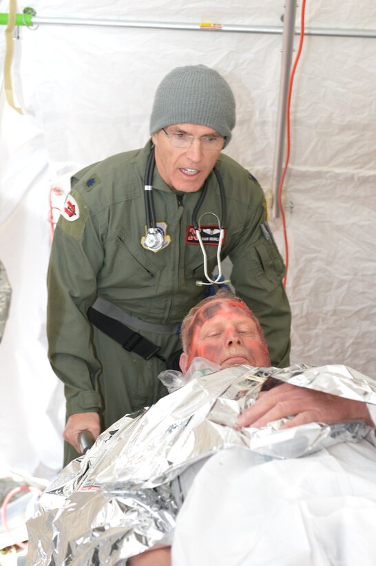 Air Force Lt. Col. Dan Noble, from the 155th Medical Group, transports a non-ambulatory victim from the decontamination tent to medical triage to treat all burns and injuries during the Chemical, Biological, Radiological, Nuclear and High Yield Explosive Enhanced Response Force Package exercise at Mead Training Site, Neb.,  April 6, 2013.
