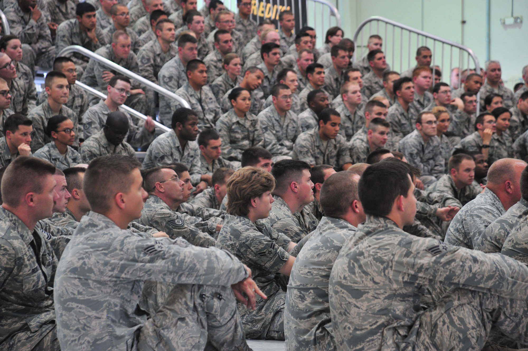 U.S. Air Force service members listen as 27th Special Operations Wing leadership provide guidance during Sexual Assault Stand-down Day at Cannon Air Force Base, N.M., June 21, 2013. During the briefing, Air Commandos were informed that behavior conducive to a culture in which sexual assault persists will not be tolerated. (Air Force photo/2nd Lt. Angelica Powell)