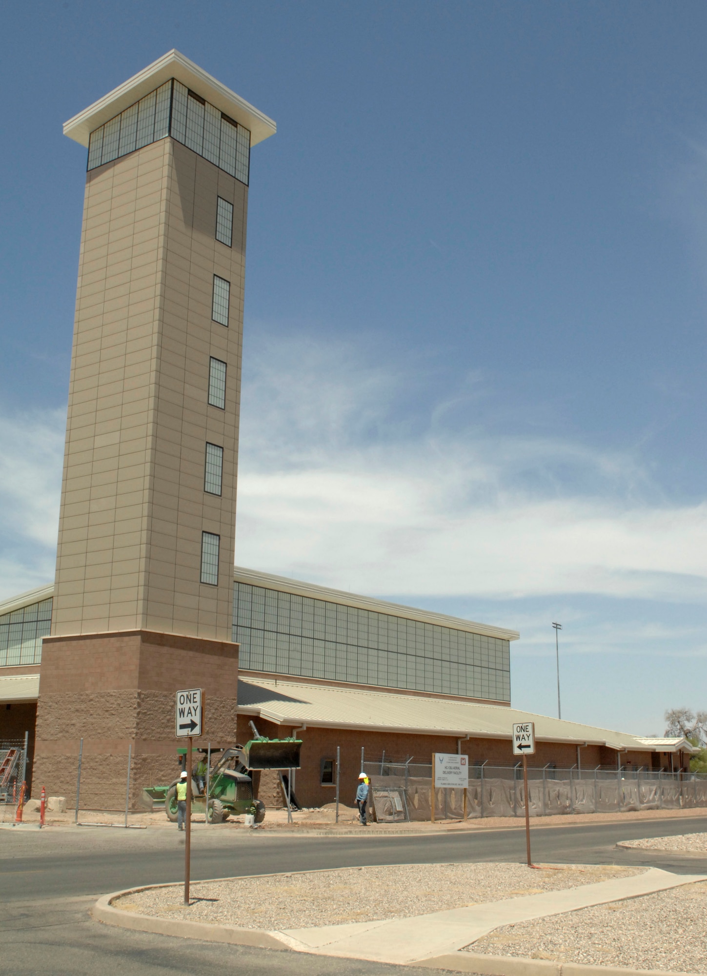 The newly constructed HC-130J Aerial Delivery Facility sits on the corner of Phoenix Street and Tempe Street at Davis-Monthan Air Force Base, Ariz., June 6, 2013. It is slated to house nine personnel, three loadmasters and six riggers, along with a parachute packing room and a wood working room, among other things. (U.S. Air Force photo by Airman 1st Class Saphfire Cook/Released)