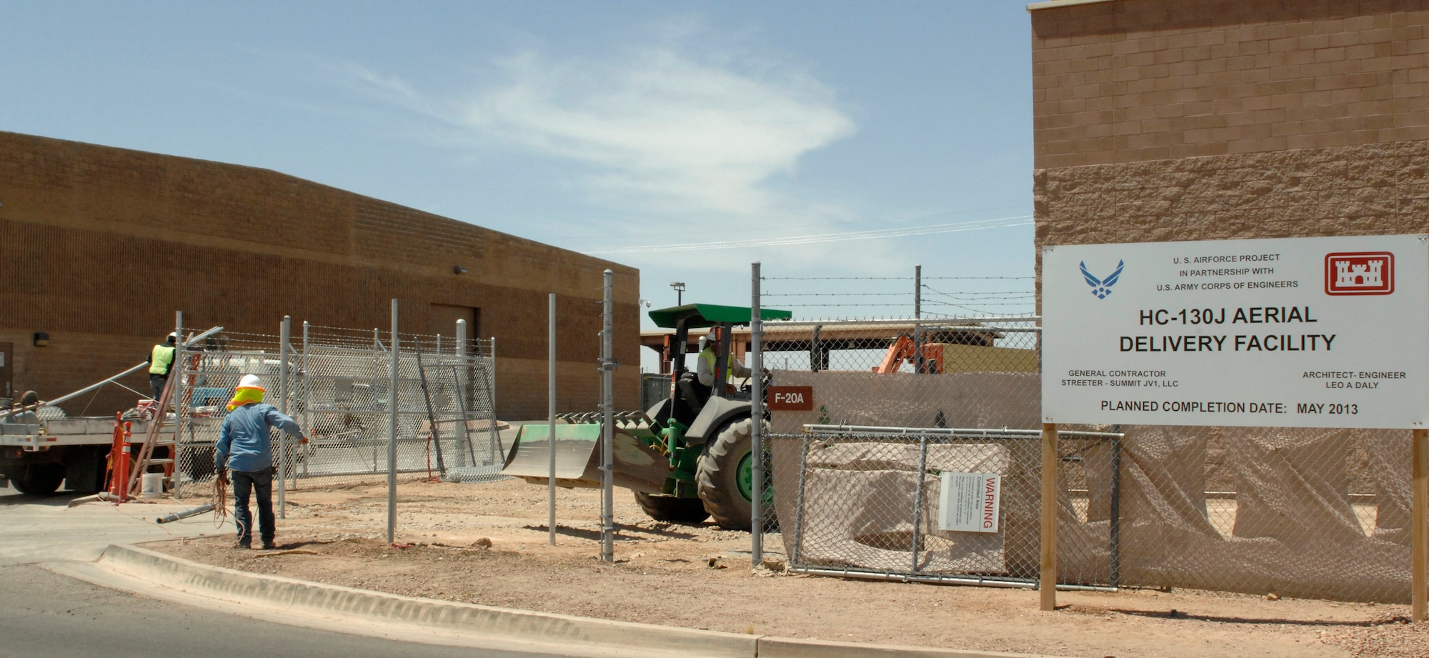 A construction worker enters the worksite of the new HC-130J Aerial Delivery Facility at Davis-Monthan Air Force Base, Ariz., June 6, 2013. The more than 20,000 square foot building is slated to open in July. It will be used to construct and rig airdrop loads. (U.S. Air Force photo by Airman 1st Class Saphfire Cook/Released)