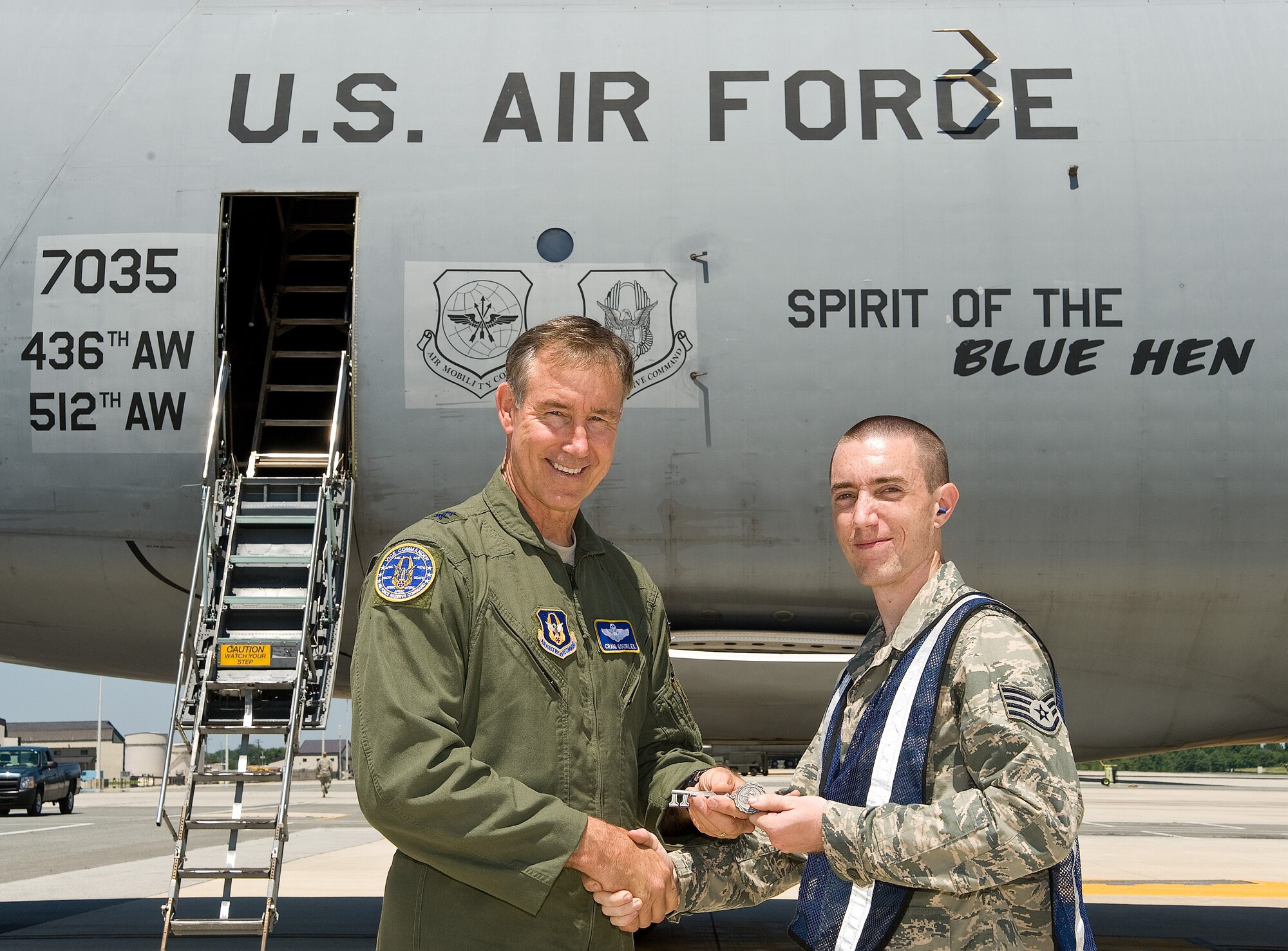 Maj. Gen. Craig N. Gourley, Air Force Reserve Command vice commander, presents the key for Dover Air Force Base, Del.'s newest C-5M Super Galaxy aircraft named "Spirit of the Blue Hen," to Staff Sgt. James Combs, 436th Aircraft Maintenance Squadron, June 21, 2013. Gourley piloted the aircraft from Georgia to Dover alongside a 709th Airlift Squadron aircrew, marking the first time an all-Reserve aircrew delivered a C-5M to Dover AFB. (U.S. Air Force/Roland Balik)