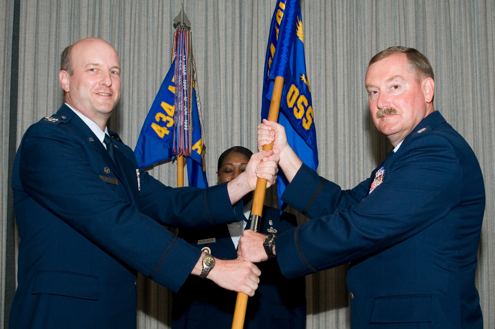 Lt. Col. Douglas Gullion, 434th Operations Support Squadron commander, receives the unit guidon from Col. Christopher Amend, 434th Operations Group commander, during a change of command ceremony here June 1, 2013. Gullion replaced Lt. Col. Larry Shaw as the new 434th OSS commander. (U.S Air Force photo/Staff Sgt. Andrew McLaughlin)
