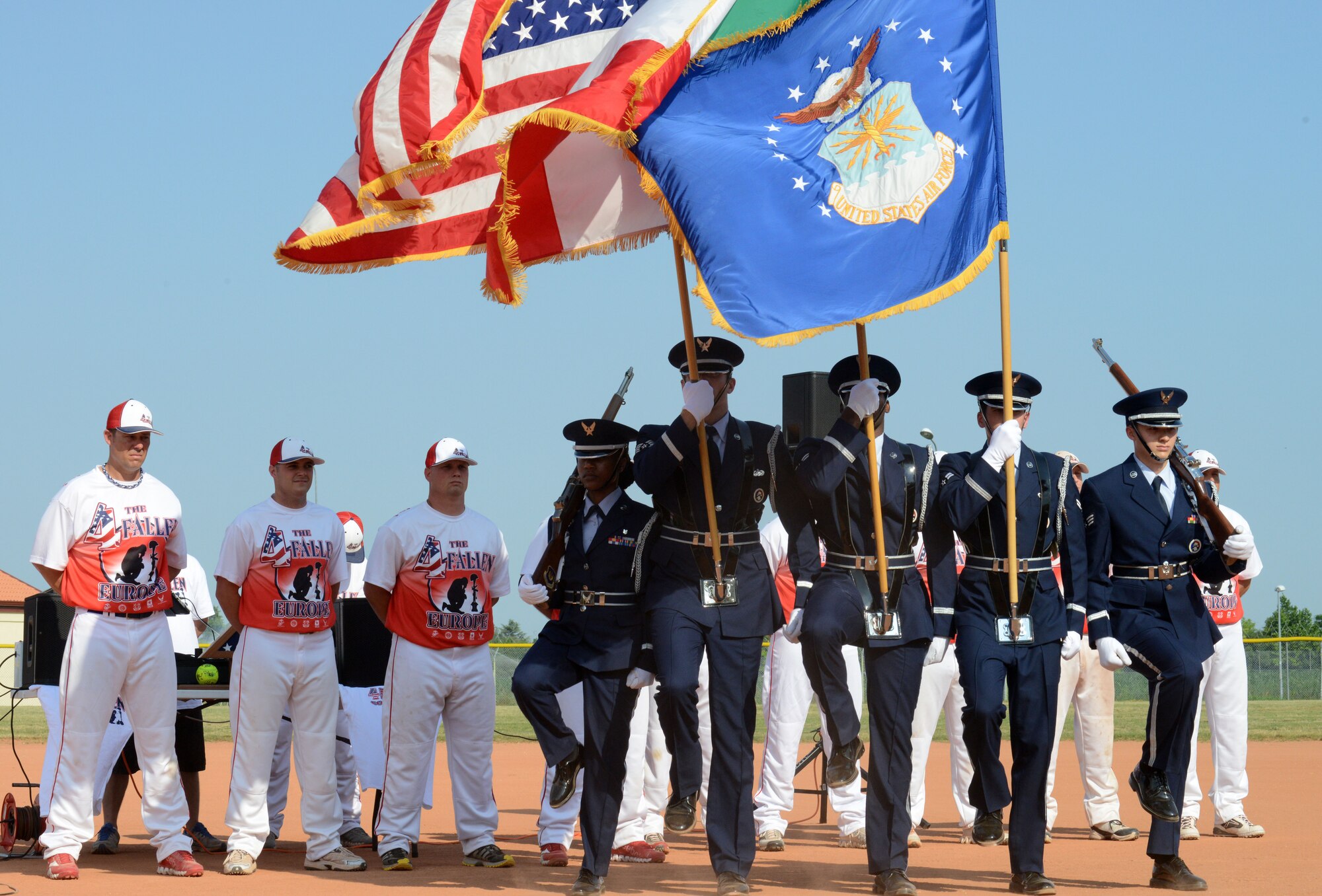 The base Honor Guard presents the colors at a softball tournament June 21, 2013, at Aviano Air Base, Italy. The non-profit organization, 4 the Fallen Europe, provides tributes to fallen and wounded veterans and their families through time-honored ceremonies and events. (U.S. Air Force photo/ Airman Ryan Conroy) 