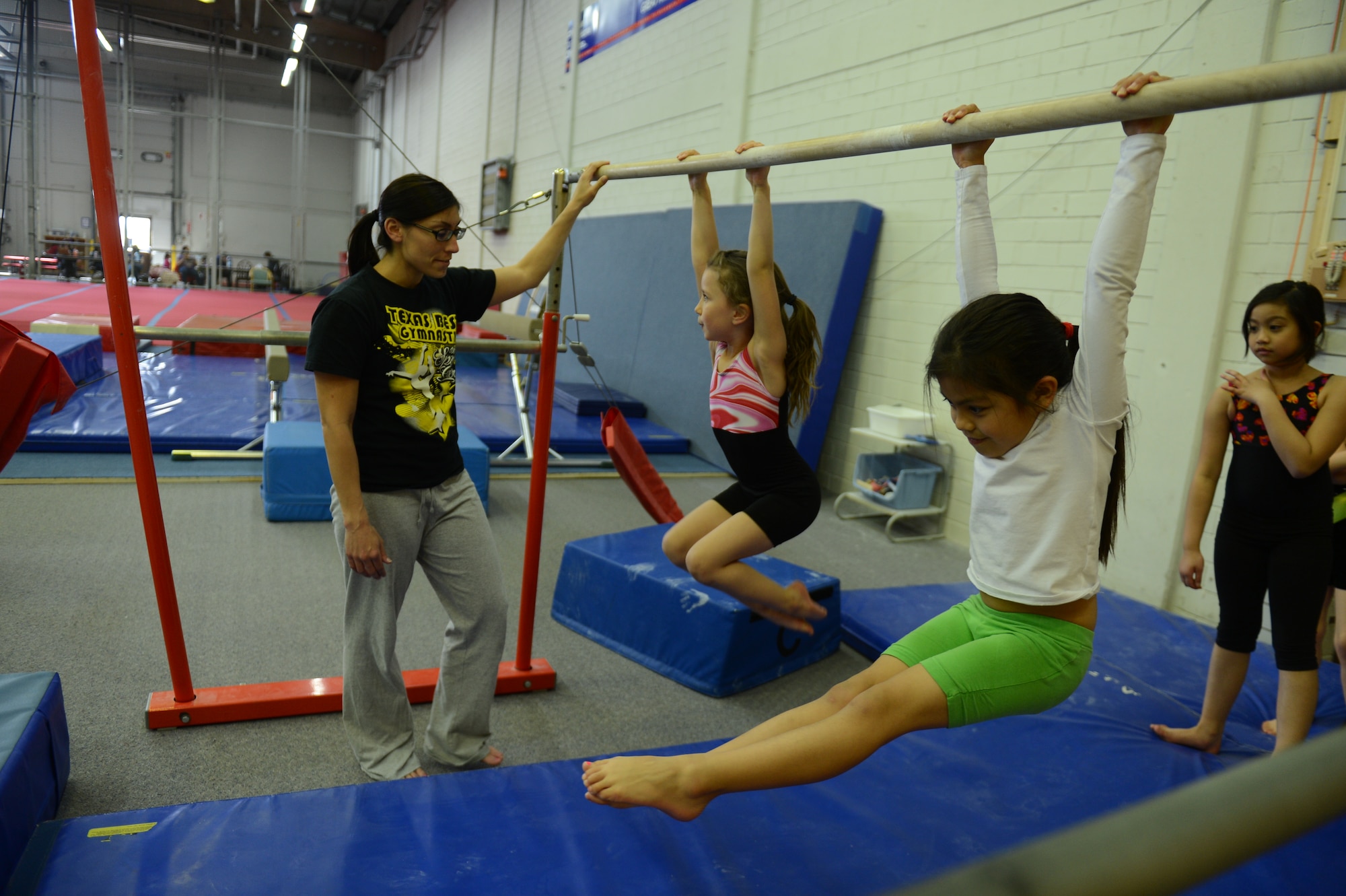 BITBURG ANNEX, Germany -- Children practice on equipment inside the new gymnastics gym location May 24, 2013. The bigger facility aims to foster a safer environment for the students and therefore increase the progression of each gymnast. (U.S. Air Force photo by Airman 1st Class Gustavo Castillo/Released)