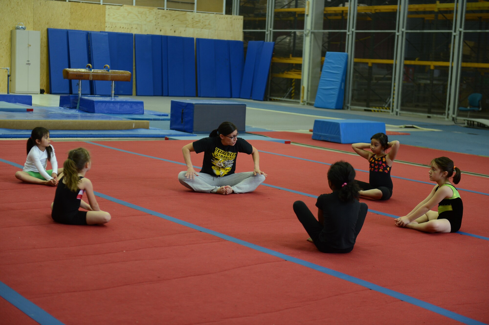 BITBURG ANNEX, Germany -- A gymnastics class stretches before working out in the new gymnastics gym May 24, 2013. Due to the larger space, classes can overlap and meet the current needs of families. (U.S. Air Force photo by Airman 1st Class Gustavo Castillo/Released)