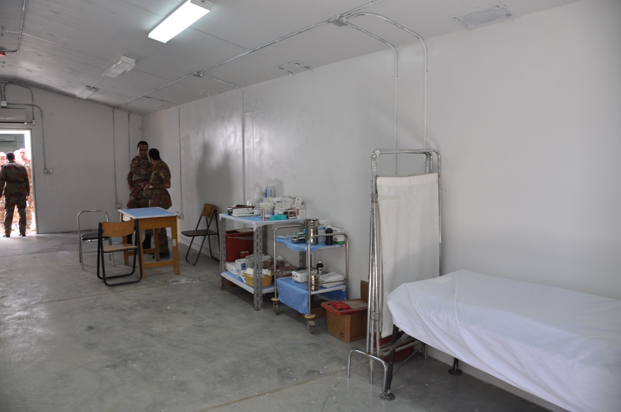 Service members from the Egyptian medical staff have a discussion inside the orthopedic clinic before the re-opening of the El Salam Egyptian field hospital on Bagram Airfield, Afghanistan, June 22. The field hospital had been closed as the unit there prepared for performing their changeover and equipment accountability processes (U.S. Air Force photo/Tech. Sgt. Rob Hazelett)